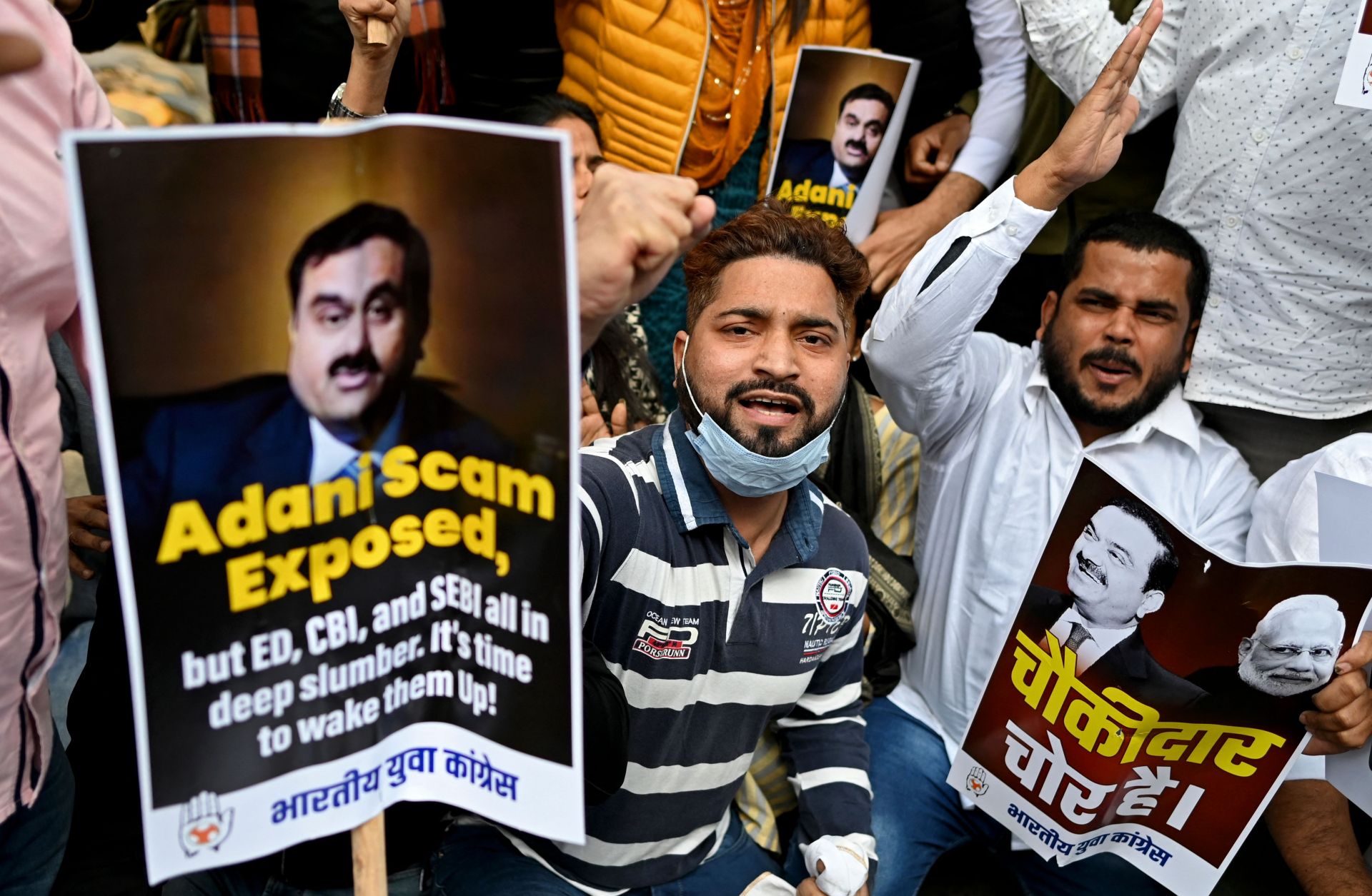 Activists who are part of the youth wing of the opposition Indian National Congress party hold placards and shout slogans during a protest outside the regional headquarters of India's Life Insurance Corporation in New Delhi, India, on Feb. 7, 2023. The protesters are calling for an inquiry into allegations of major accounting fraud at the Adani Group.