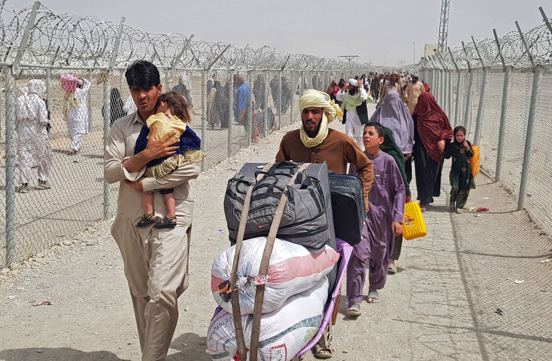 Stranded Afghan nationals arrive to return back to Afghanistan at the Pakistan-Afghanistan border crossing point in Chaman on Aug. 16, 2021. 