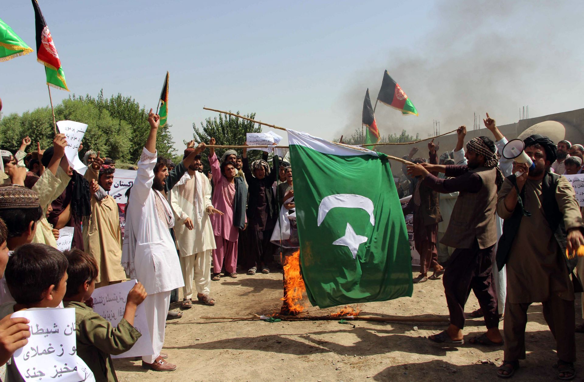 Afghan protesters burn a Pakistani flag during a demonstration in Helmand Province in 2016.