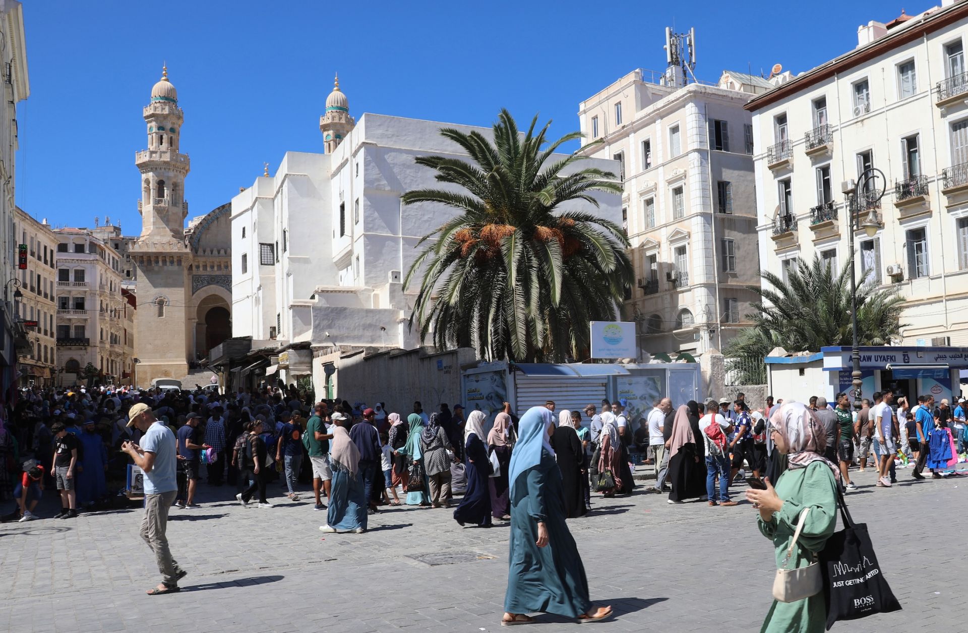 People walk through a main square in Algeria's capital of Algiers on Sept. 15, 2024.