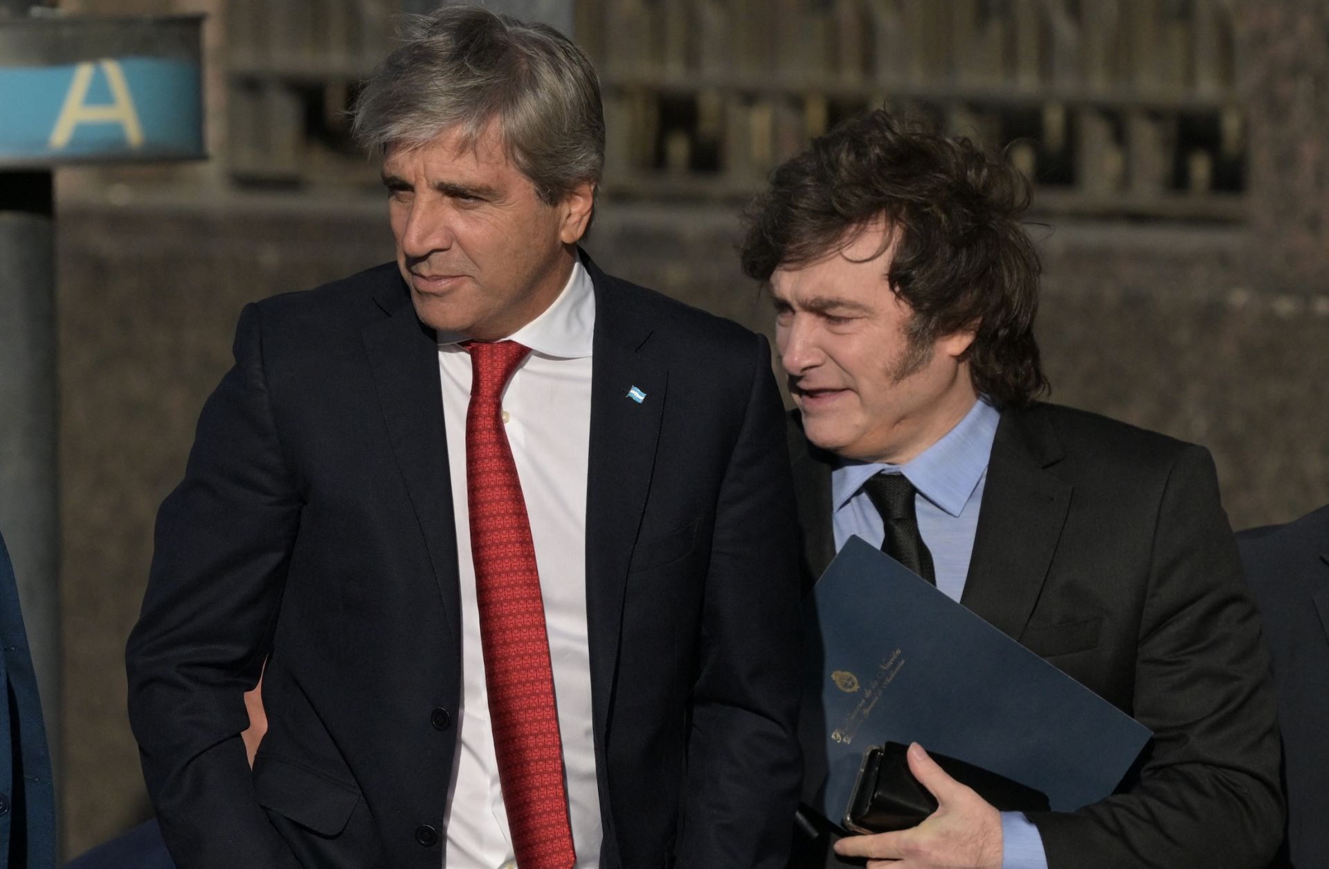 Argentina's economy minister Luis Caputo (L) and Argentine President Javier Milei walk from the Casa Rosada Presidential Palace after a meeting on April 14, 2025.