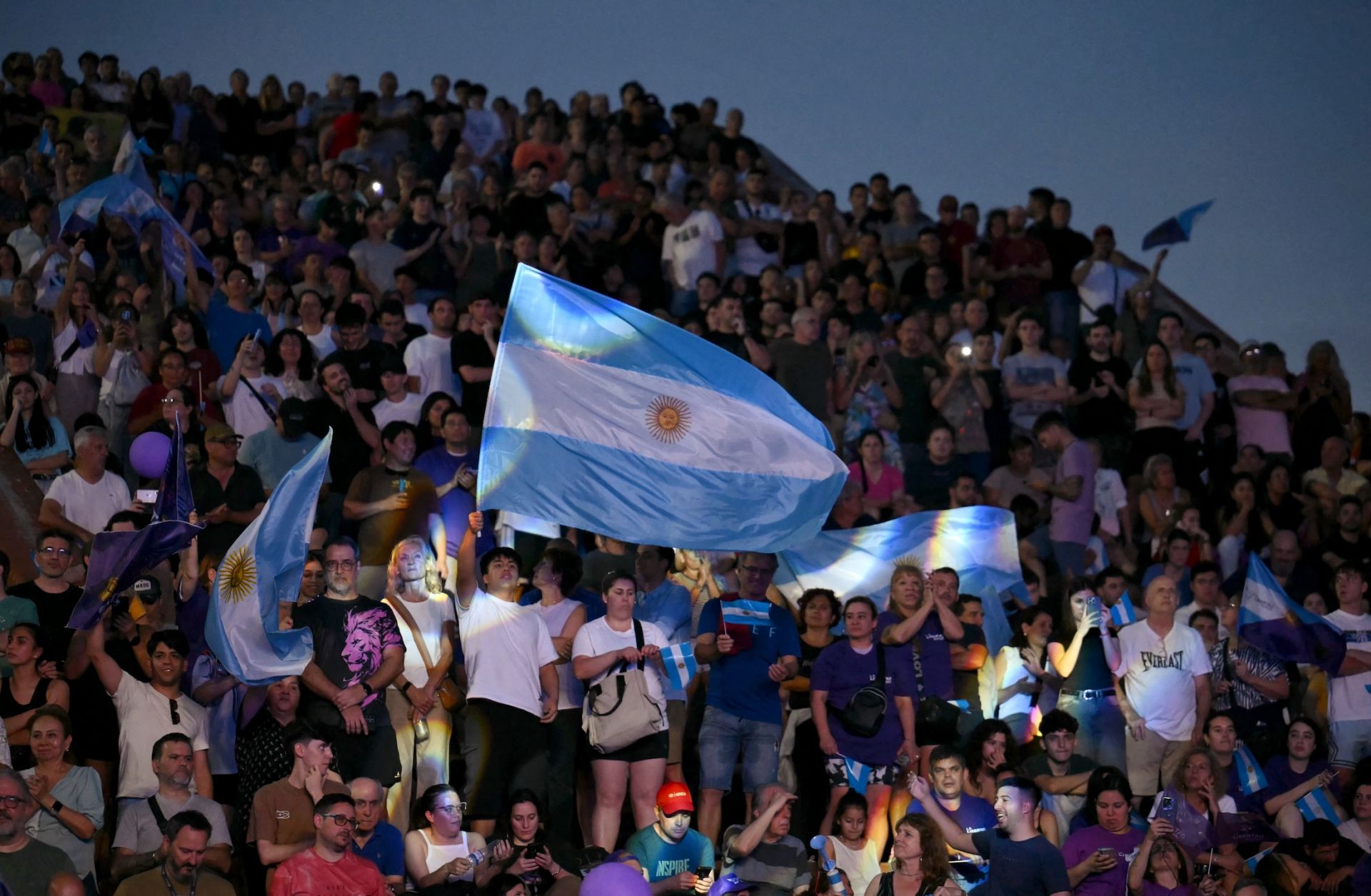 Supporters of Argentine President Javier Milei's Liberty Advances (LLA) party wave flags during a campaign rally in Rosario, Argentina, on Oct. 23, 2025.
