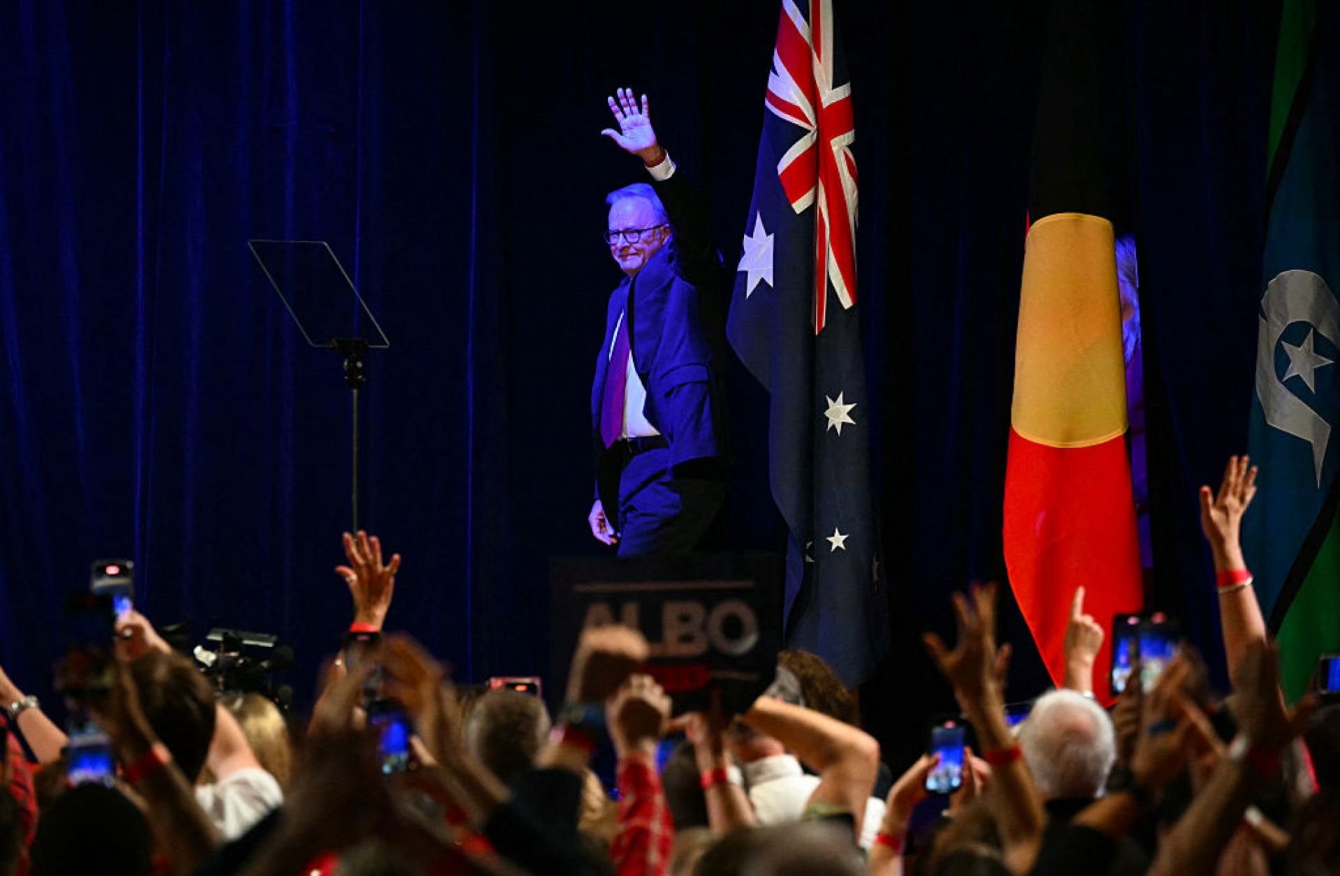 After winning the general election, Australia's Prime Minister Anthony Albanese waves as he arrives onstage at the Labor Party election night event in Sydney on May 3, 2025. 