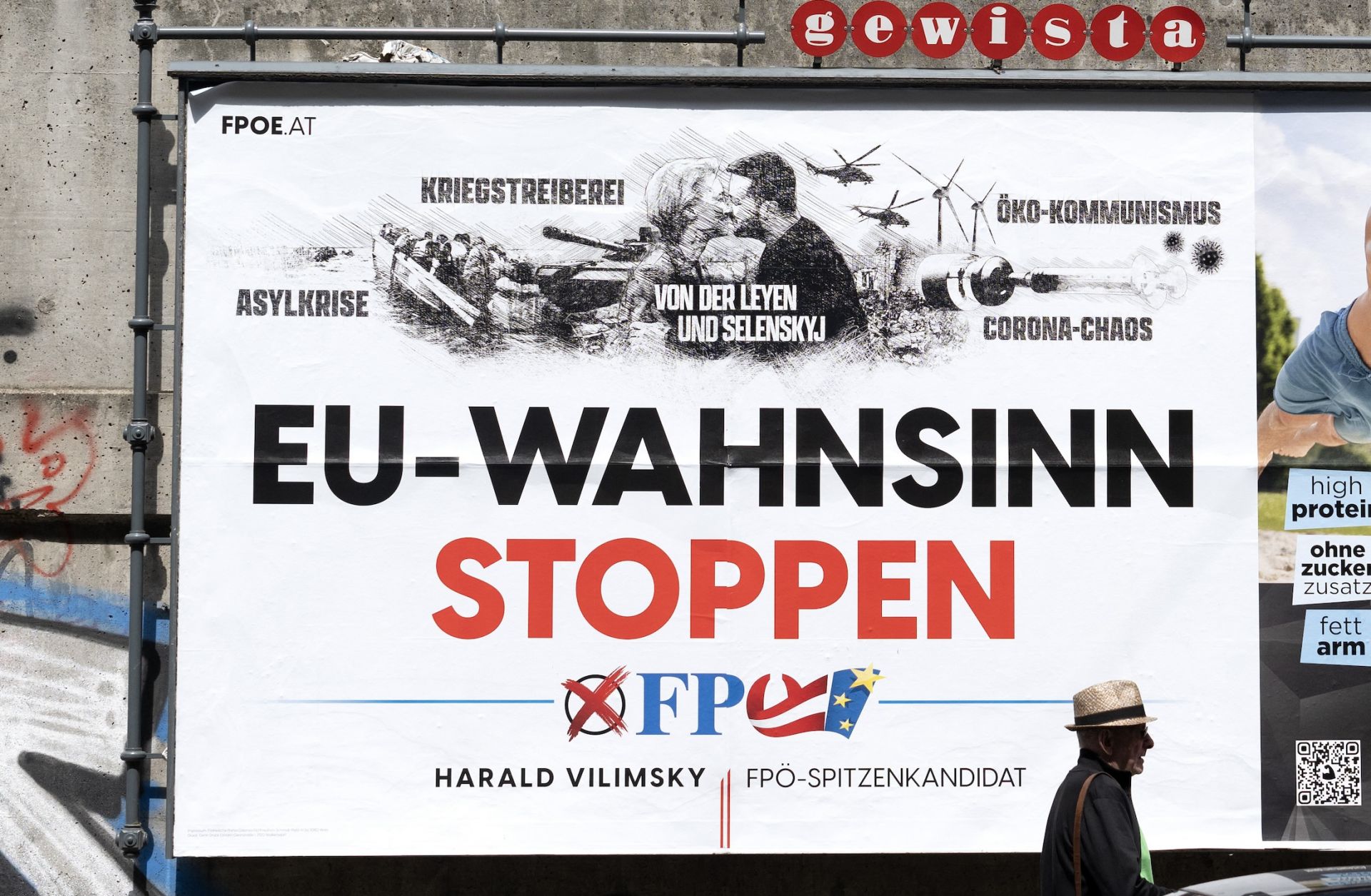 A pedestrian walks past a billboard with an election poster for Harald Vilimsky, the top candidate of Austria's right-wing Freedom Party in the June European Parliament elections, on May 13, 2024. 