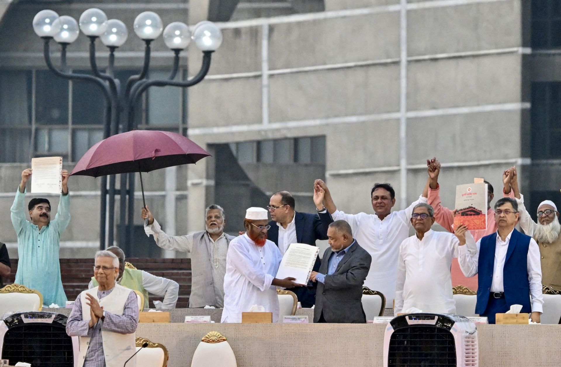 Representatives of various Bangladeshi political parties present the July National Charter at the South Plaza of the National Parliament in Dhaka on Oct. 17, 2025. 