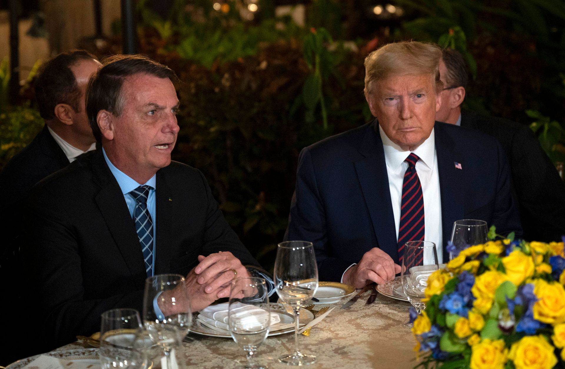 Amid rising levels of unemployment and inequality, anti-establishment political movements will continue to catapult Trump-like leaders to power. U.S. President Donald Trump (right) speaks with Brazilian President Jair Bolsonaro during a dinner at Mar-a-Lago in Palm Beach, Florida, on March 7, 2020.