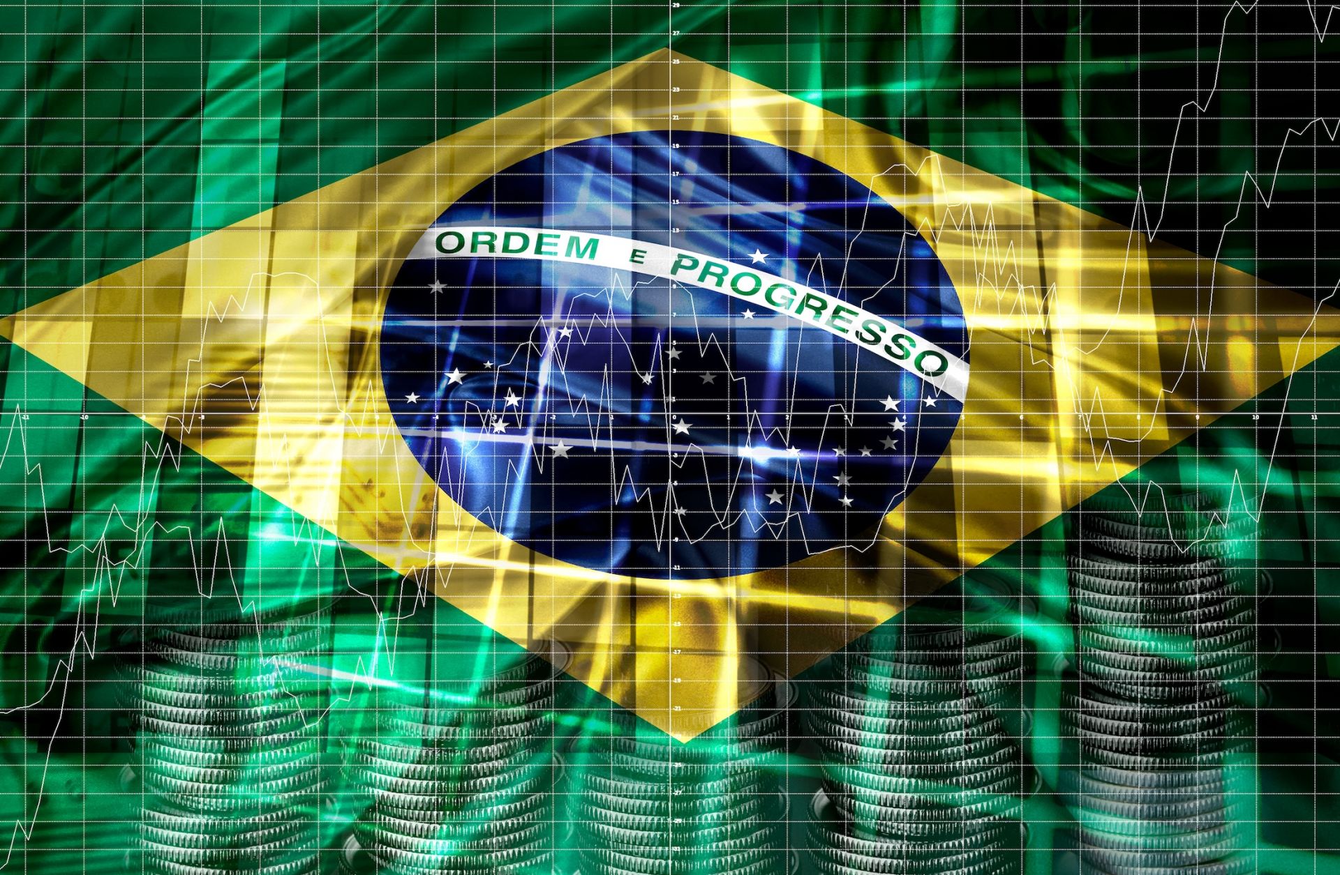 A digital illustration of the Brazilian flag with economic and financial indicators. 