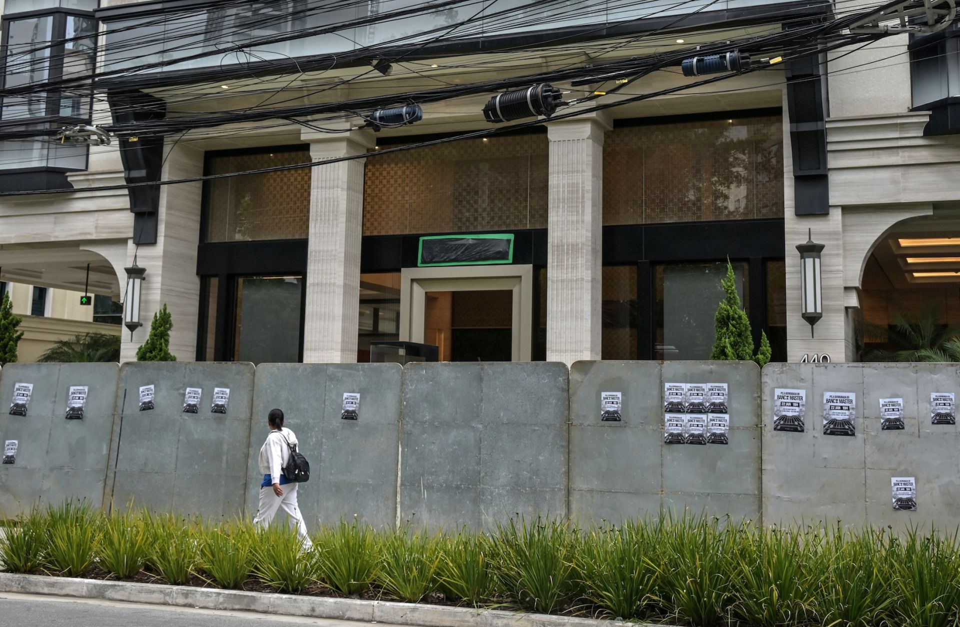 A passerby walks past the Banco Master building in Sao Paulo on Jan. 22, 2026, after Brazil's central bank ordered its shutdown due to a major liquidity crunch and "serious violations" of financial regulations. A passerby walks past the Banco Master building in Sao Paulo on Jan. 22, 2026, after Brazil's central bank ordered its shutdown due to a major liquidity crunch and "serious violations" of financial regulations.