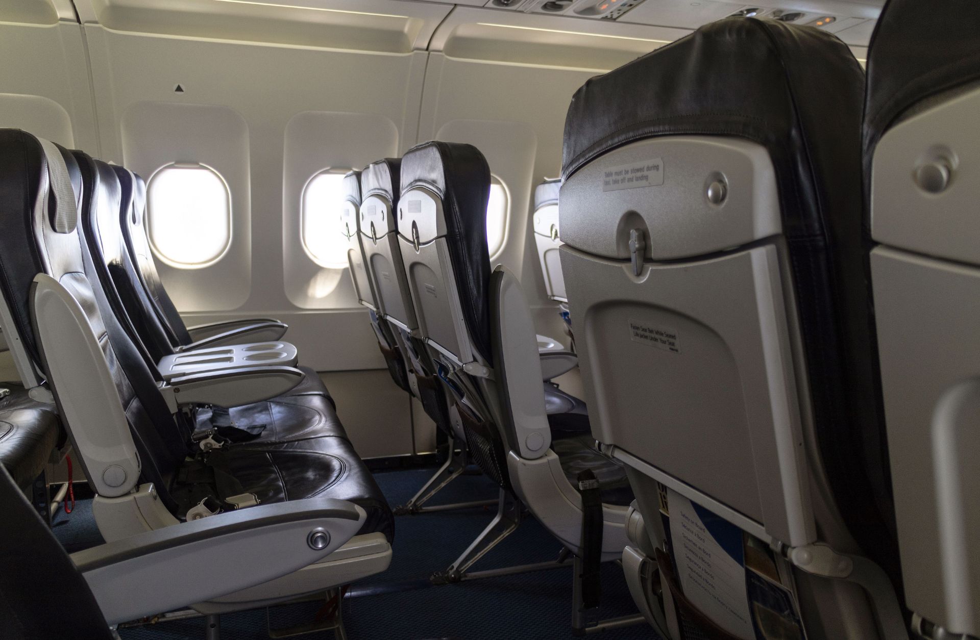 This photo shows a rows of seats on a passenger aircraft. 
