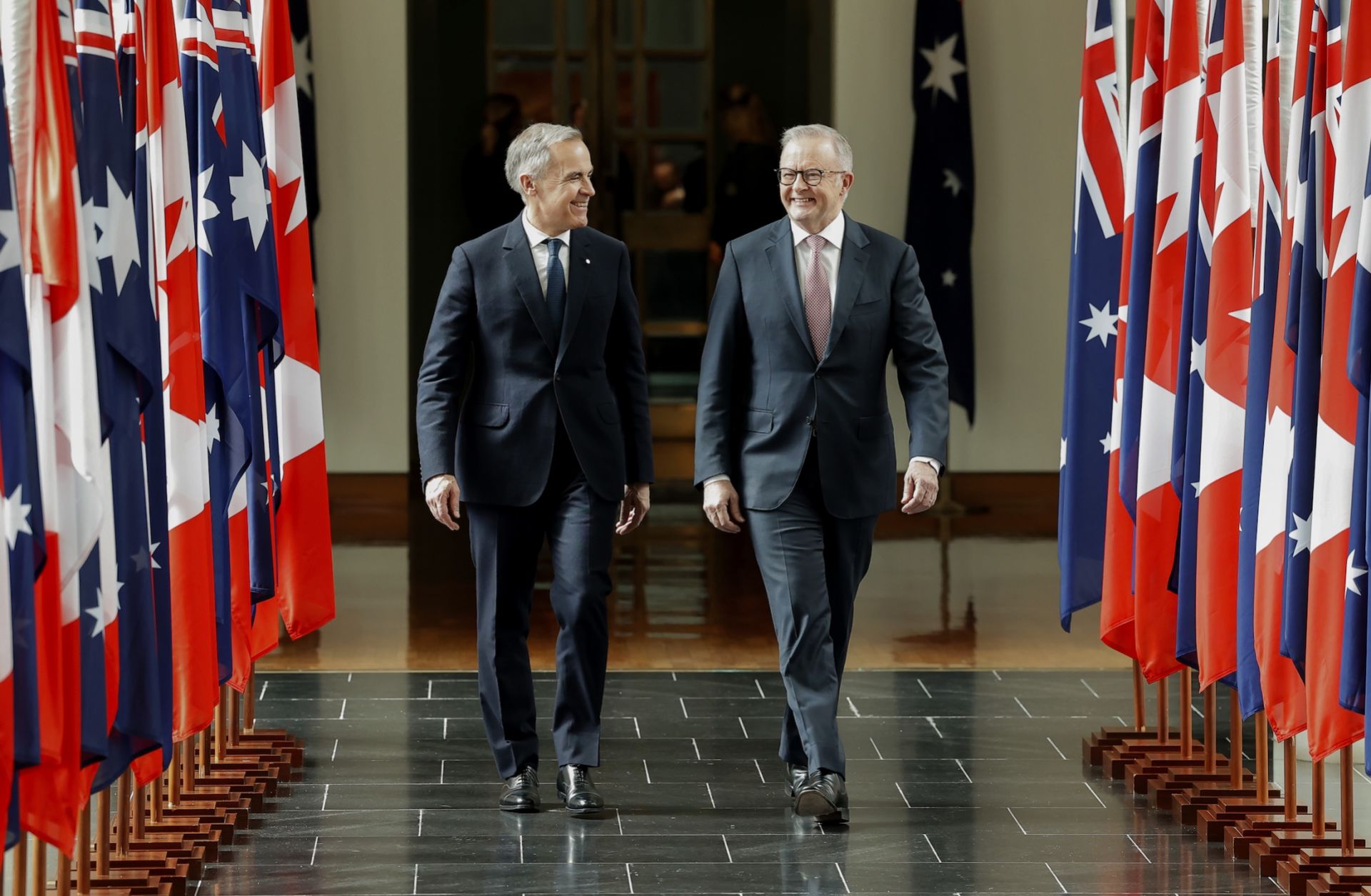 Canadian Prime Minister Mark Carney walks with Australian Prime Minister Anthony Albanese in Canberra, Australia, on March 5, 2026. 
