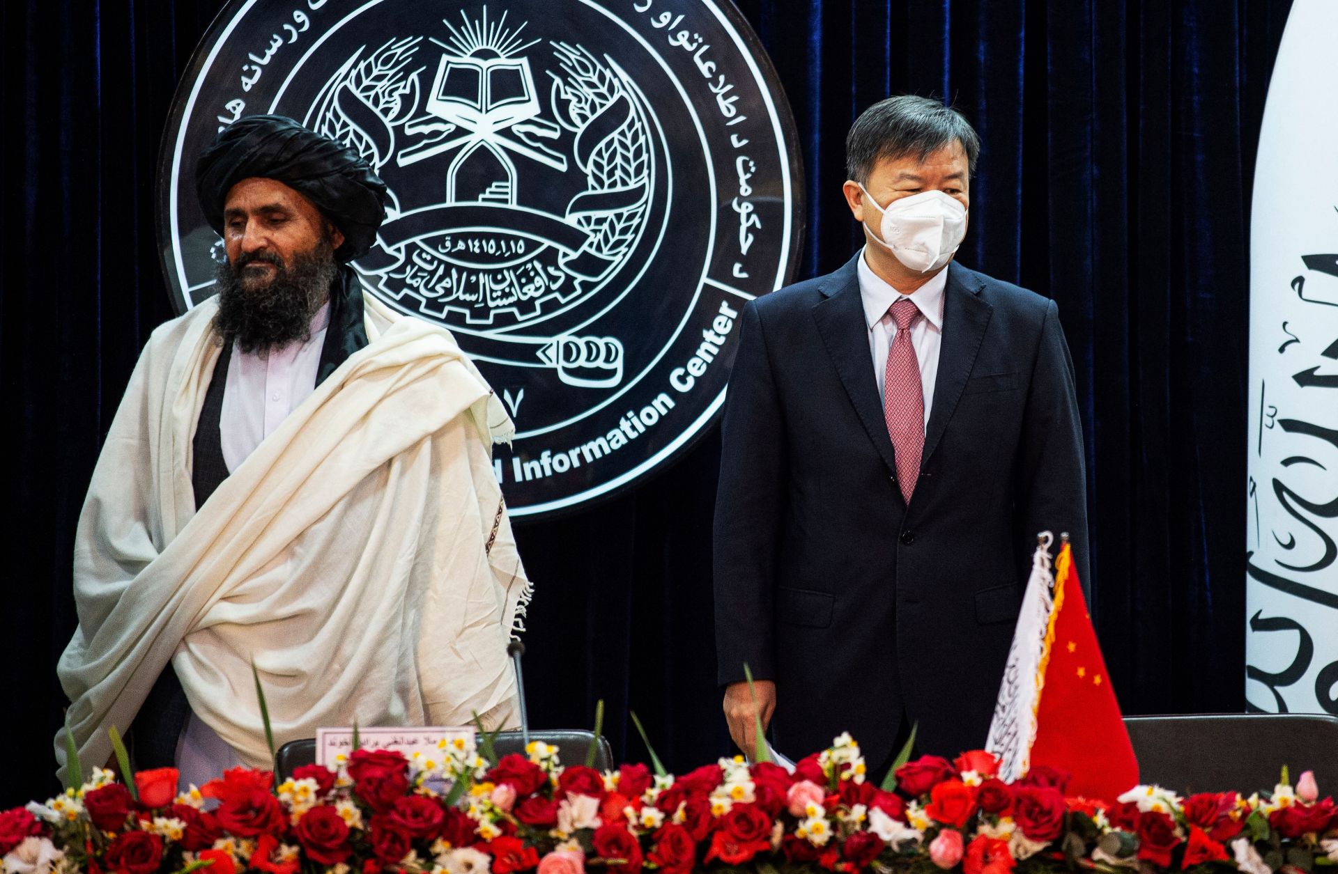 Afghanistan's acting Deputy Prime Minister, Abdul Mullah Abdul Ghani Baradar, (L) and China's Ambassador to Afghanistan, Wang Yu, (R) attend a press conference to announce an oil extraction contract with a Chinese company in Kabul, Afghanistan, on Jan. 5, 2023.