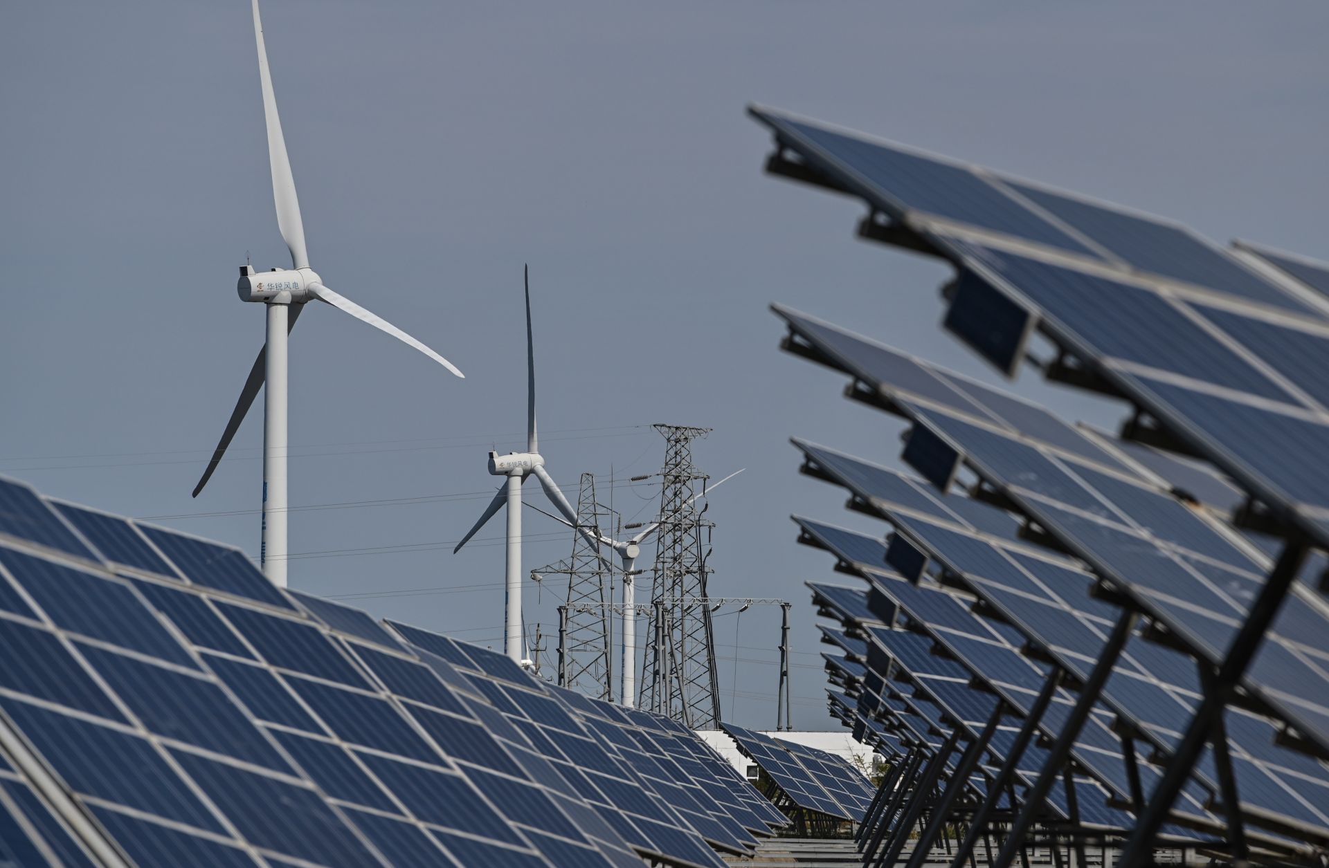 Solar panels and wind turbines work in an integrated power station in Yancheng, China, on Oct. 14, 2020.