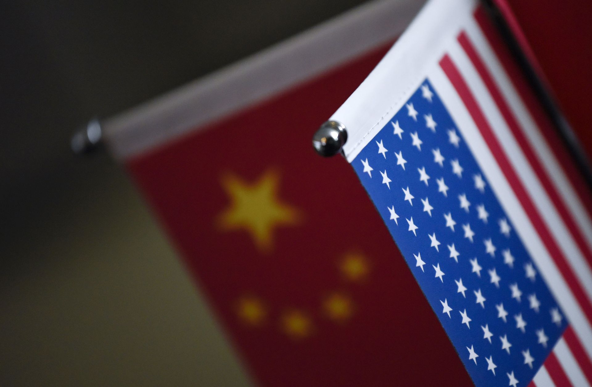 Chinese flags and American flags are displayed at a business in Beijing. 