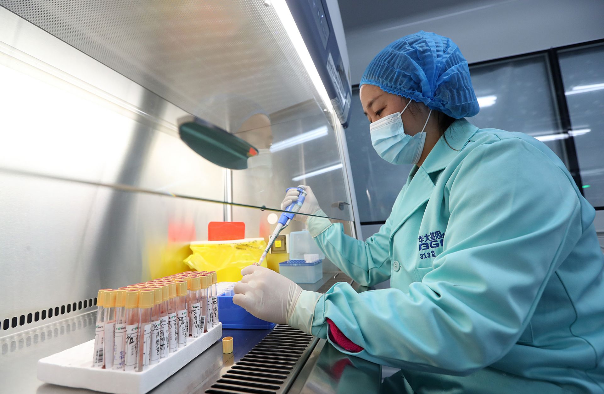 This Dec. 26, 2018, photo shows a researcher working in a Beijing Genomics Institute laboratory in Kunming, China.