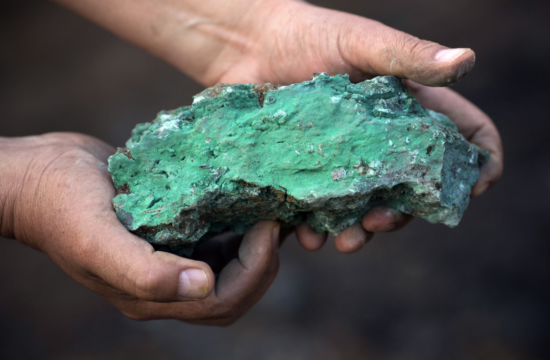 A man holds a copper-rich piece at a mine in Kolwezi, Democratic Republic of Congo, in July 2016. 