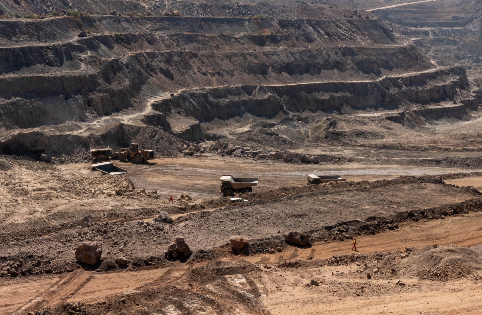 Trucks haul away ore from a pit in the Chinese-owned Tenke Fungurume Mine, one of the largest copper and cobalt mines in the world, in southeastern Democratic Republic of the Congo on June 17, 2023.