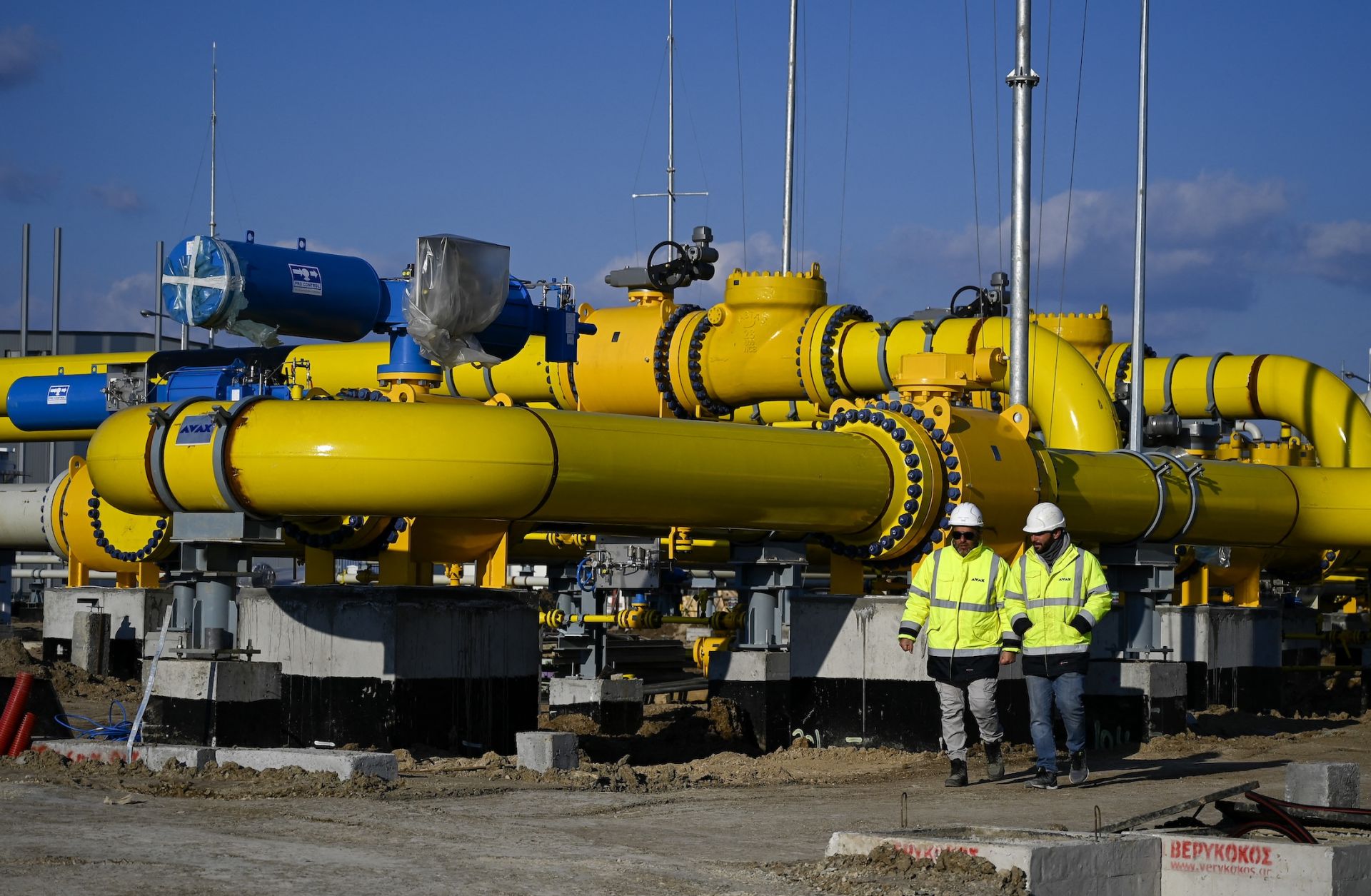 Employees walk at the construction site of a gas metering station, part of the pipeline link between Bulgaria and Greece near the village of Malko Kadievo, on March 18, 2022. 