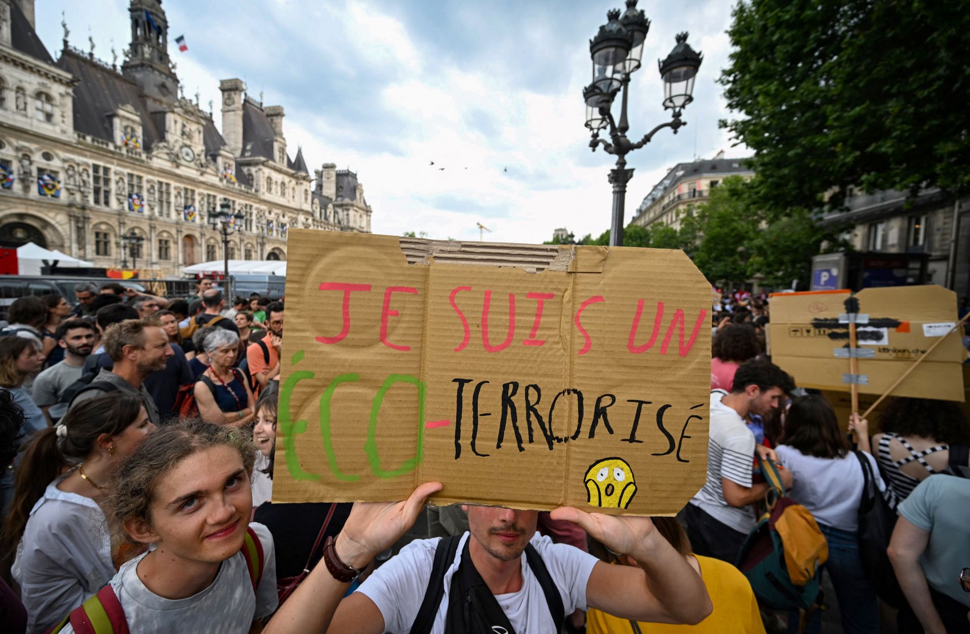 A protester holds a sign reading "I'm an eco-terrorised" during a rally to support the environmental movement Les Soulevements de la Terre (Uprisings of the Earth) near city hall in Paris, France, on June 21, 2023.
