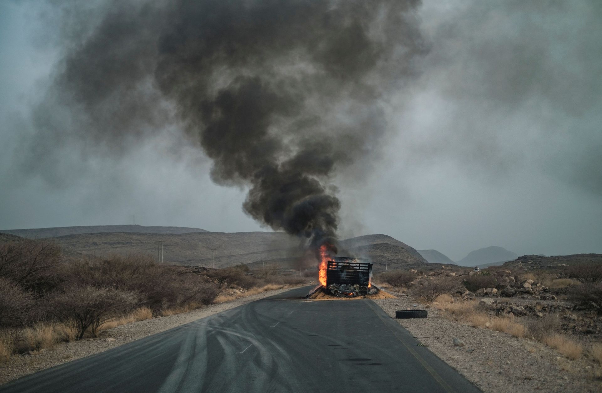 A truck, carrying grains to Tigray and belonging to the World Food Programme (WFP), burns out on a route 80 kilometers from Semera in northeastern Ethiopia, on June 10, 2022. 