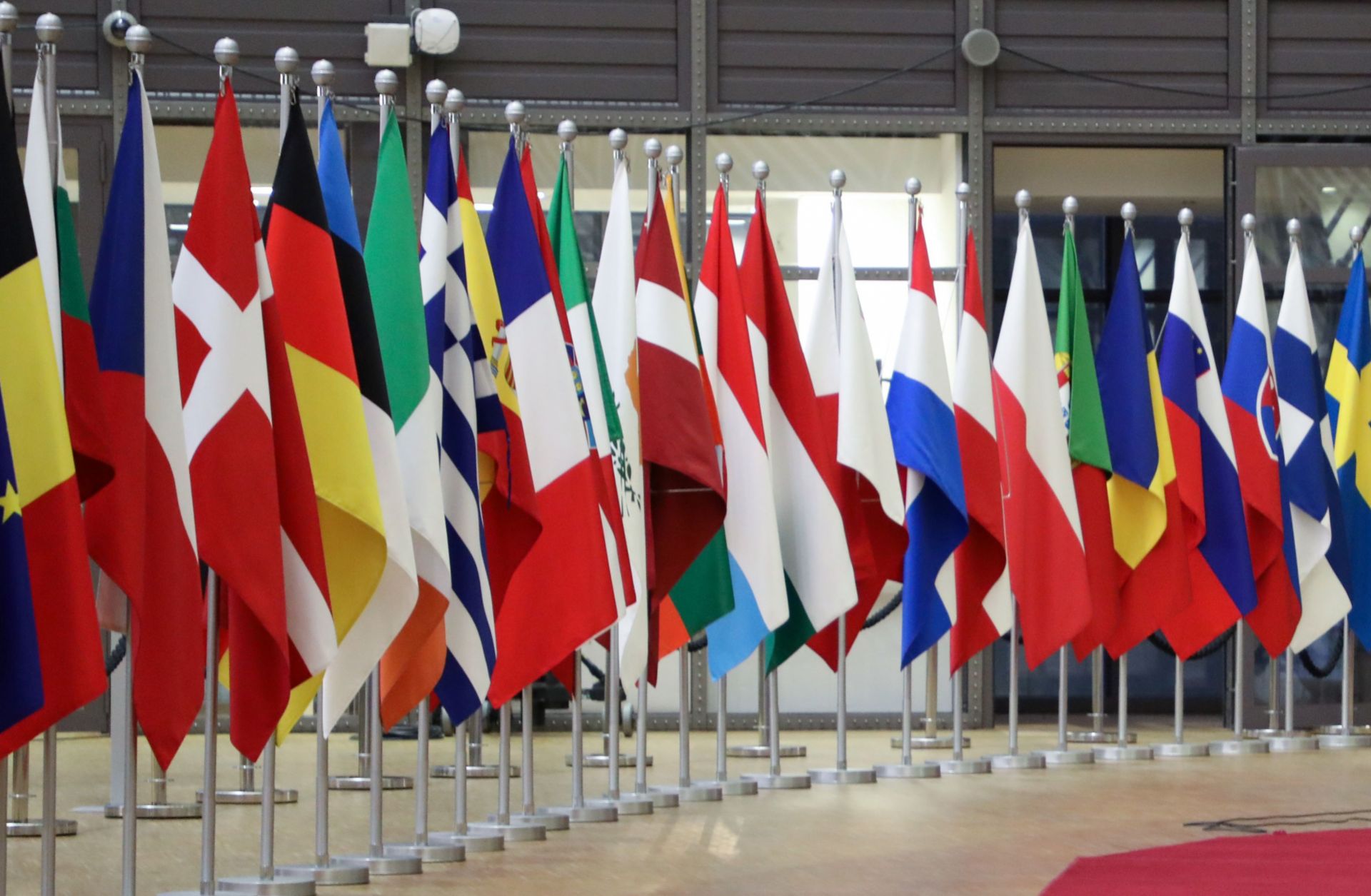 The national flags of the European Union’s 27 member states are seen in the European Council headquarters in Brussels, Belgium. 