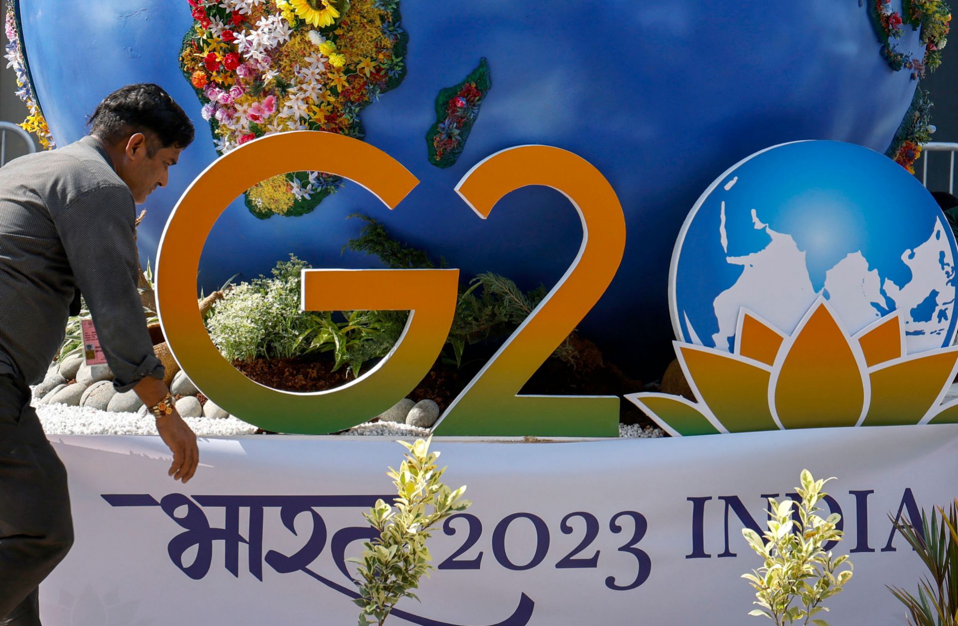 A worker decorates a G20 installation on the eve of the two-day G20 summit in New Delhi on September 8, 2023.