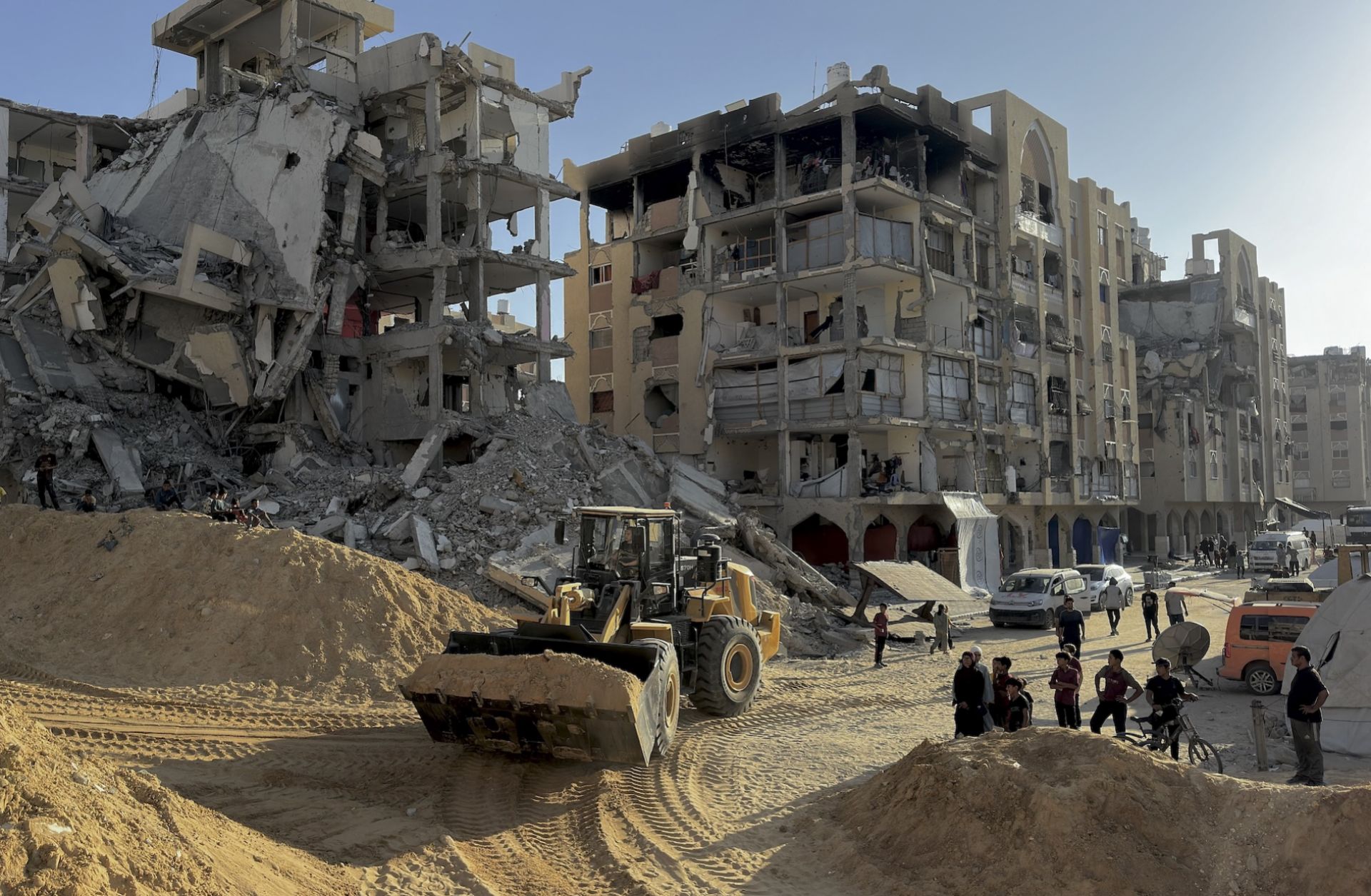 Excavation crews work amid rubble in Hamad City, west of Khan Yunis, Gaza, on Oct. 26, 2025. 