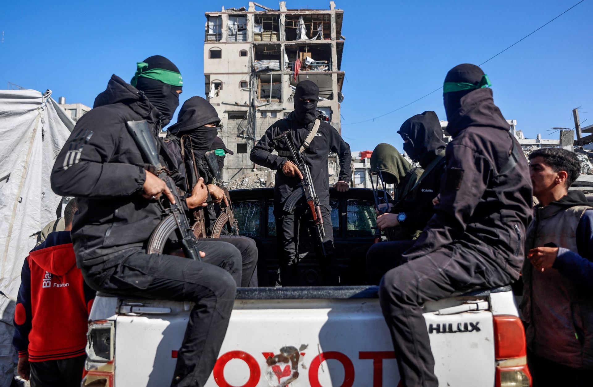 Hamas militants arrive to secure the area as Egyptian and Red Cross workers search for the bodies of the last two remaining hostages from under the rubble of the Jabalia refugee camp in northern Gaza on Dec. 1, 2025. 