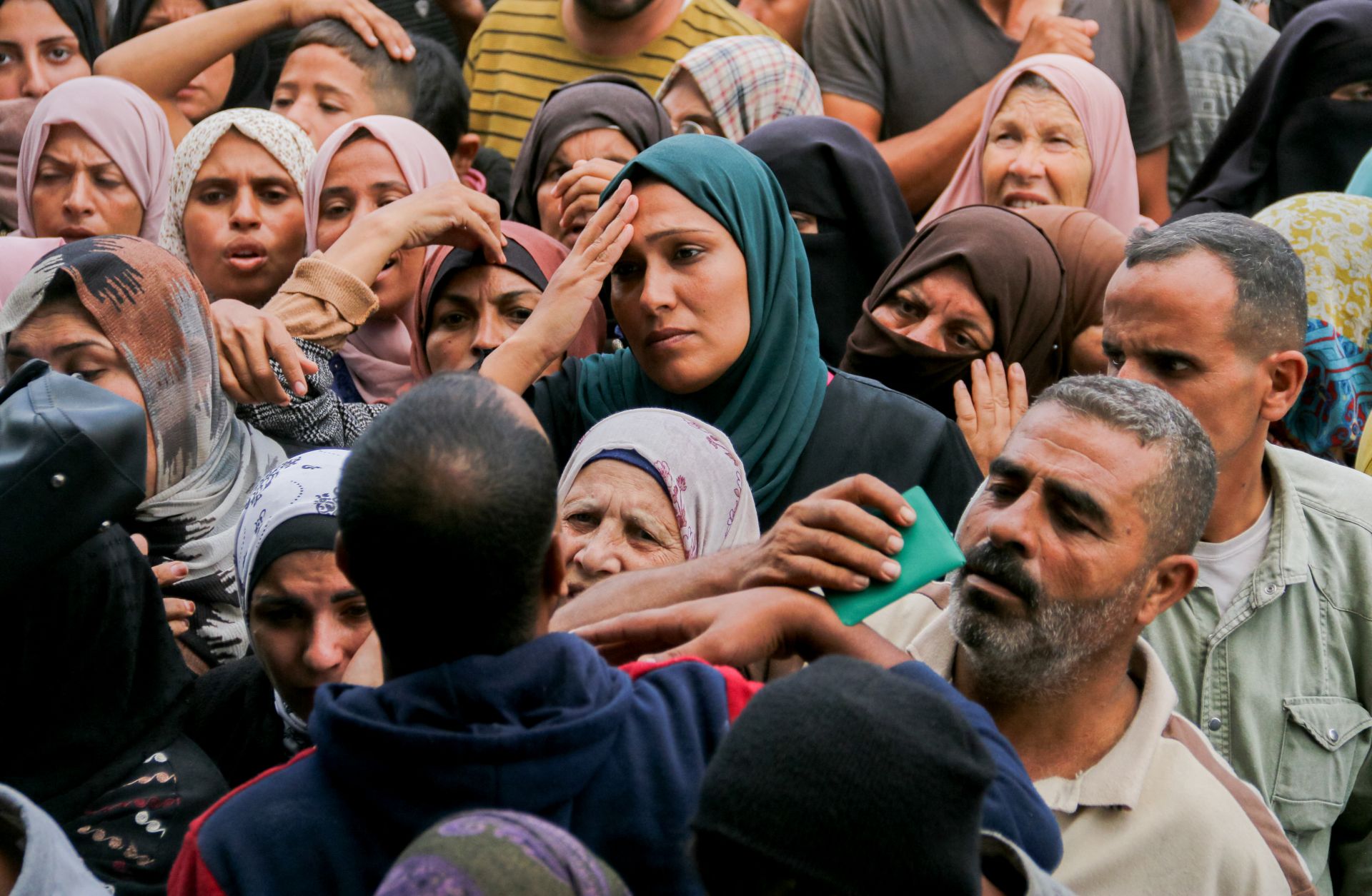 Crowds of Palestinians gather to receive food outside a U.N. aid distribution center in the Gazan city of Deir al-Balah on Nov. 2, 2024.