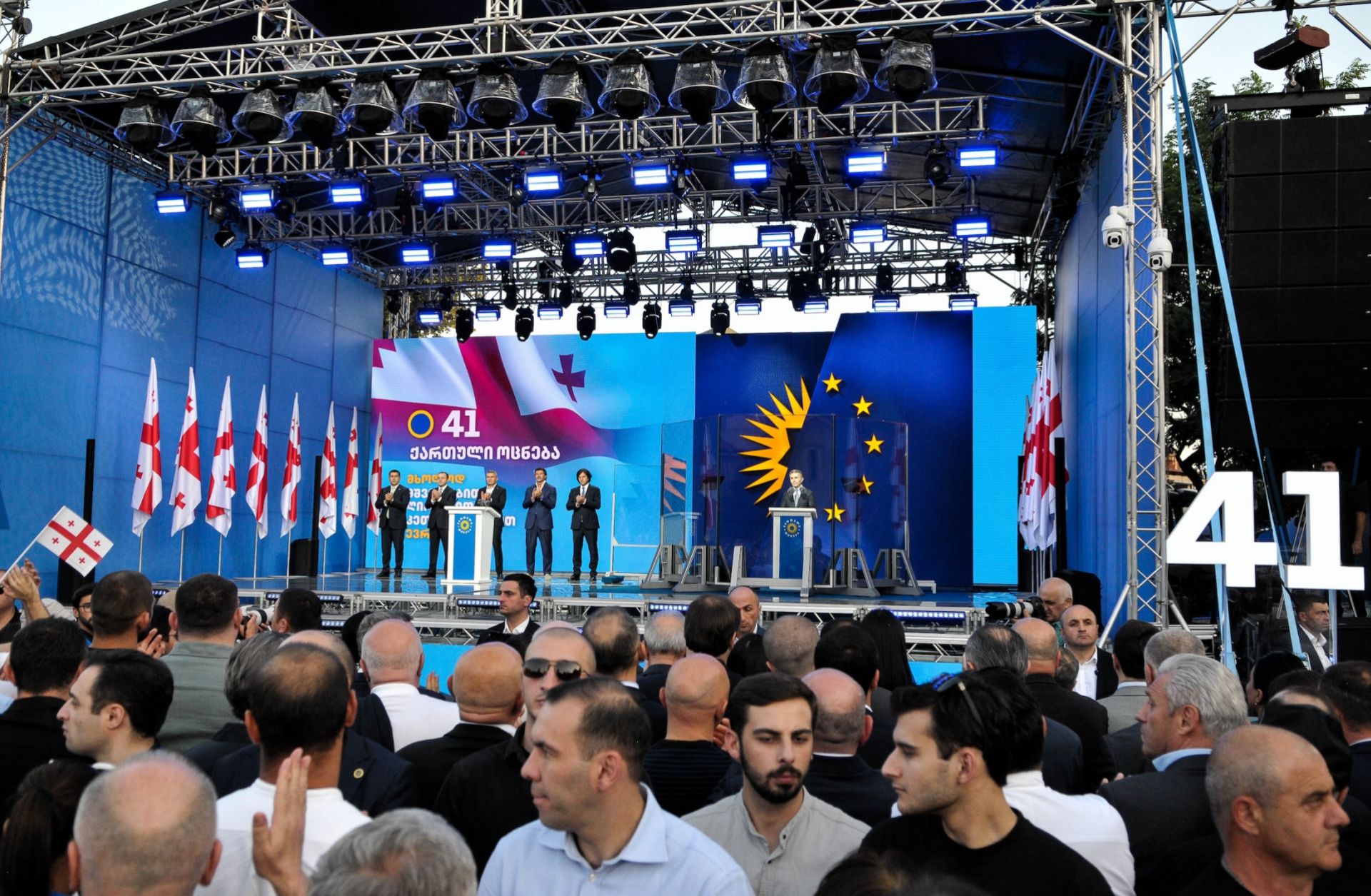 The founder of the Georgian Dream party, Bidzina Ivanishvili, stands behind the bulletproof glass as he gives a campaign speech in Gori, Georgia, on Sept. 14, 2024.