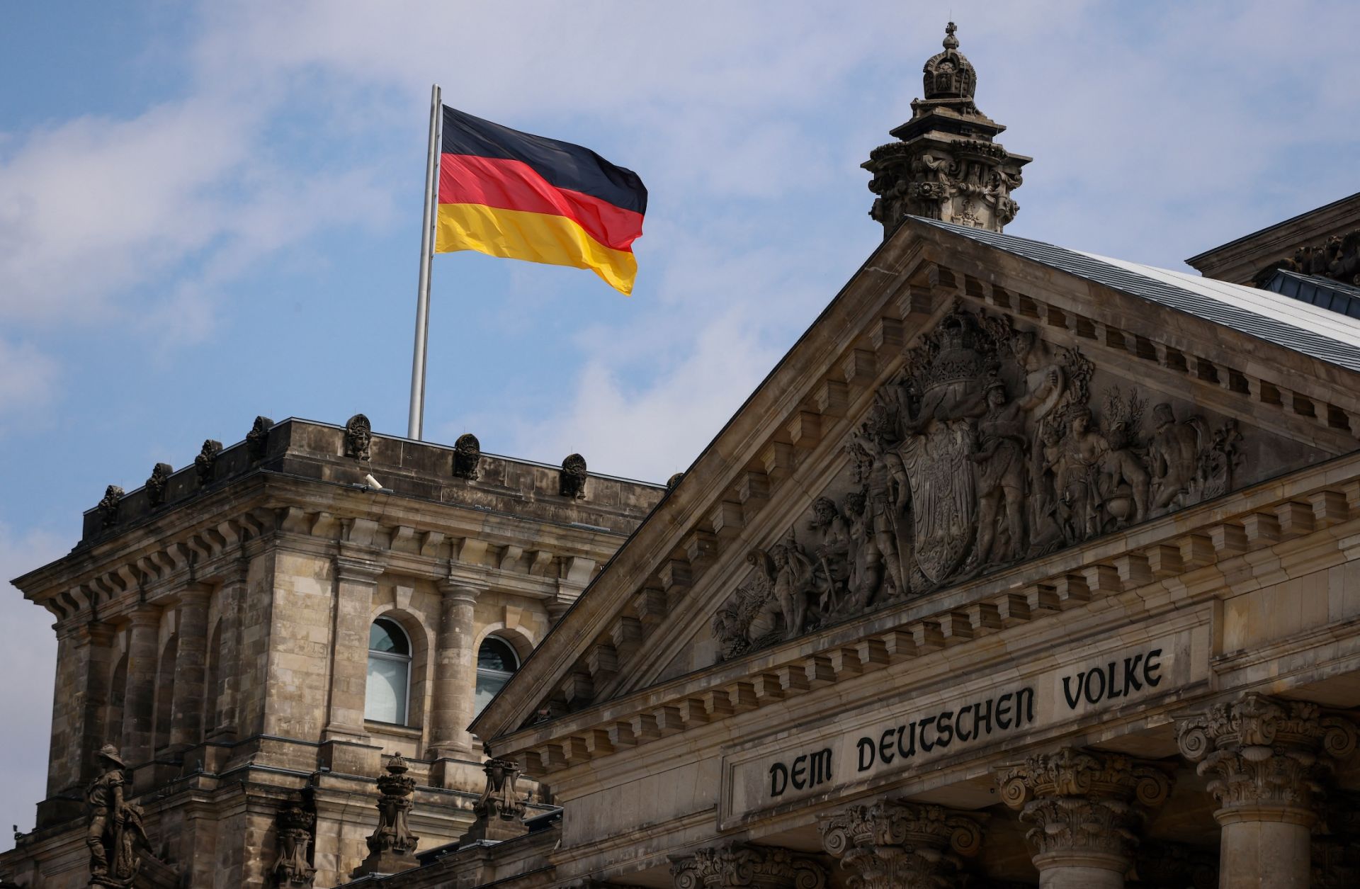 A German flag flies above the Reichstag, the building that houses the Bundestag, on July 23, 2022, in Berlin. 