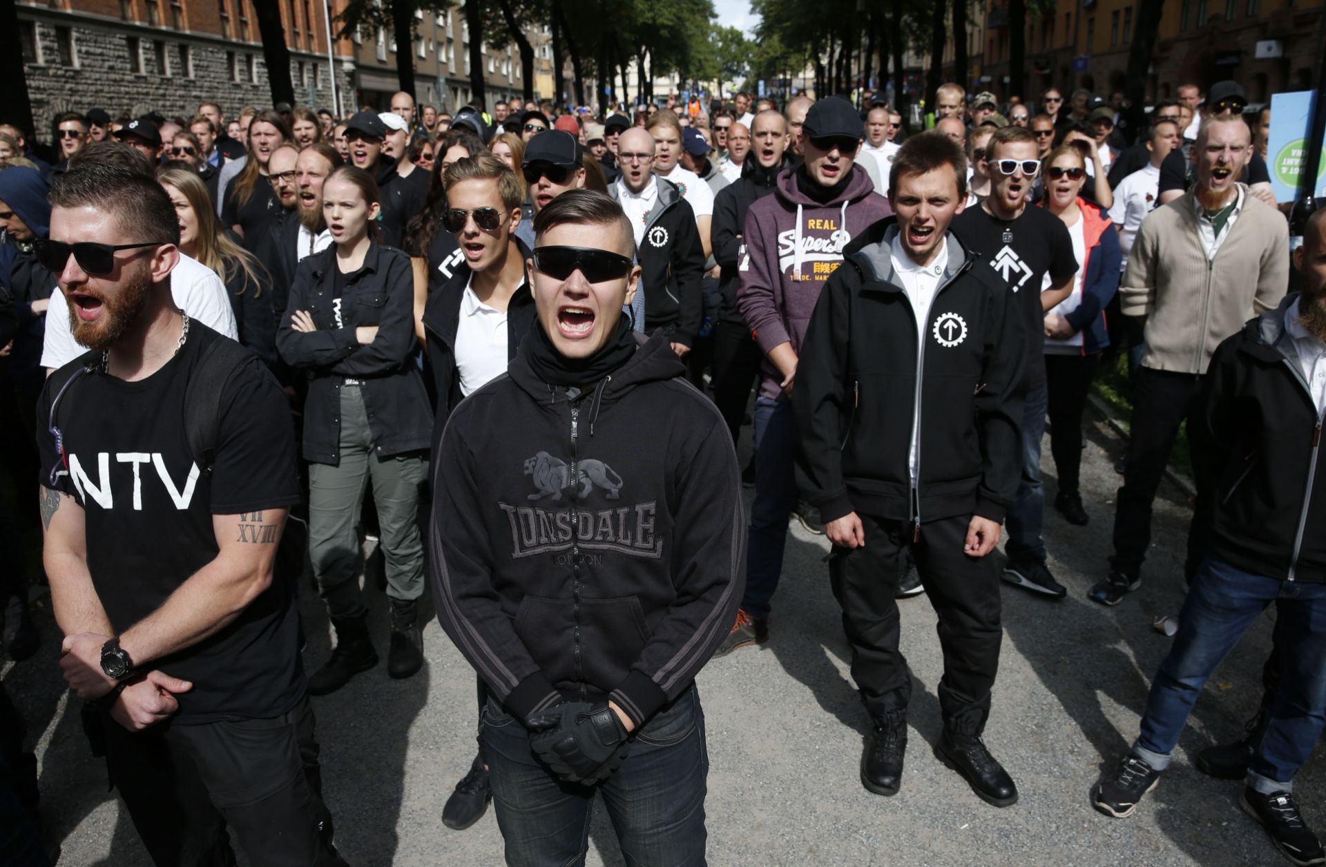 Supporters of the neo-Nazi Nordic Resistance Movement chant slogans during a demonstration in Stockholm, Sweden on Aug. 25, 2018. 