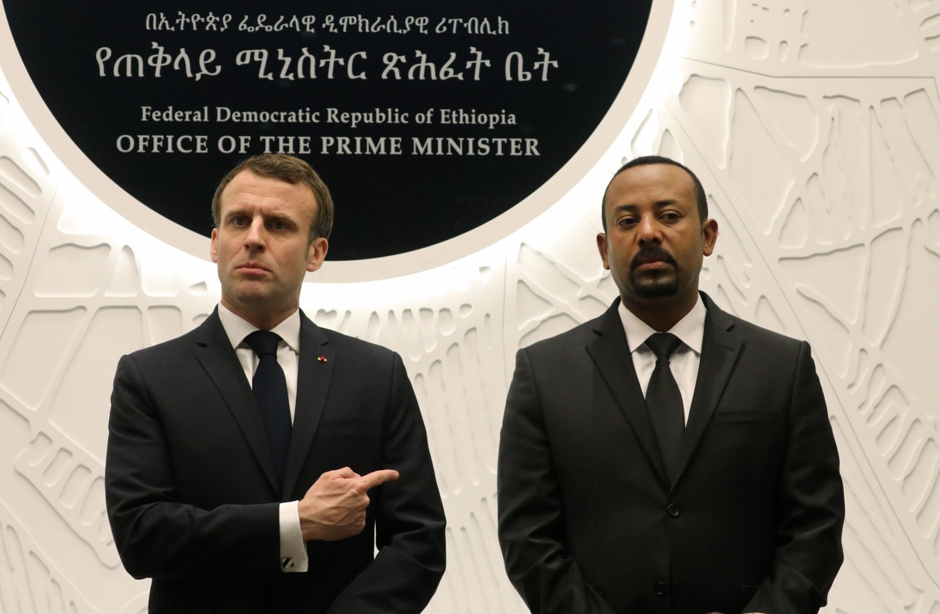 Ethiopian Prime Minister Abiy Ahmed (R) speaks with French President Emmanuel Macron after signing agreements during a meeting on March 12, 2019, in Addis Ababa.