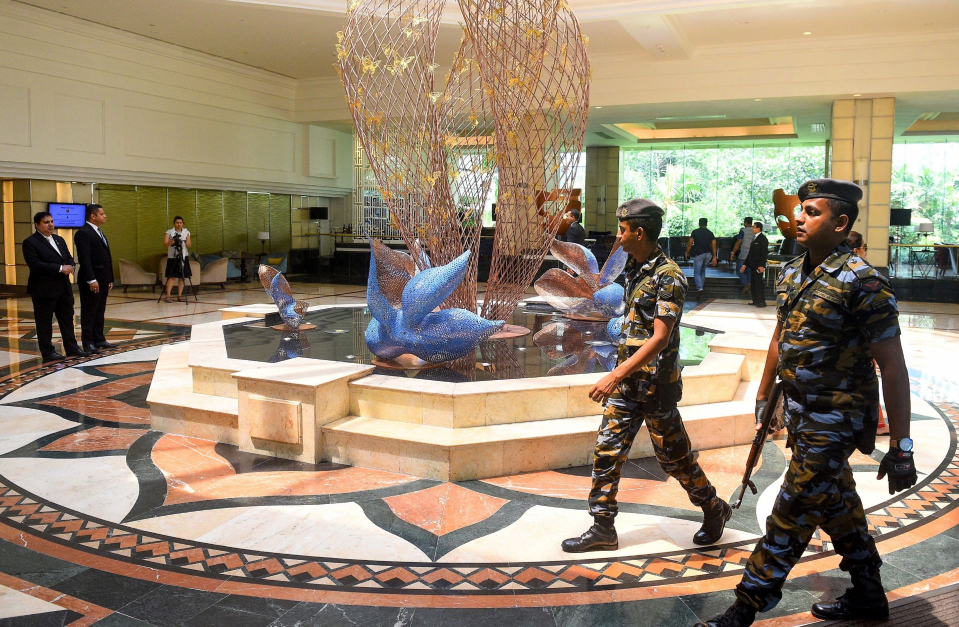 In this picture taken on May 1, 2019, Sri Lankan soldiers walk through the Cinnamon Grand Hotel lobby in Colombo. On April 21, the Cinnamon was one of three hotels hit by jihadi bombers along with three churches in attacks claimed by the Islamic State.