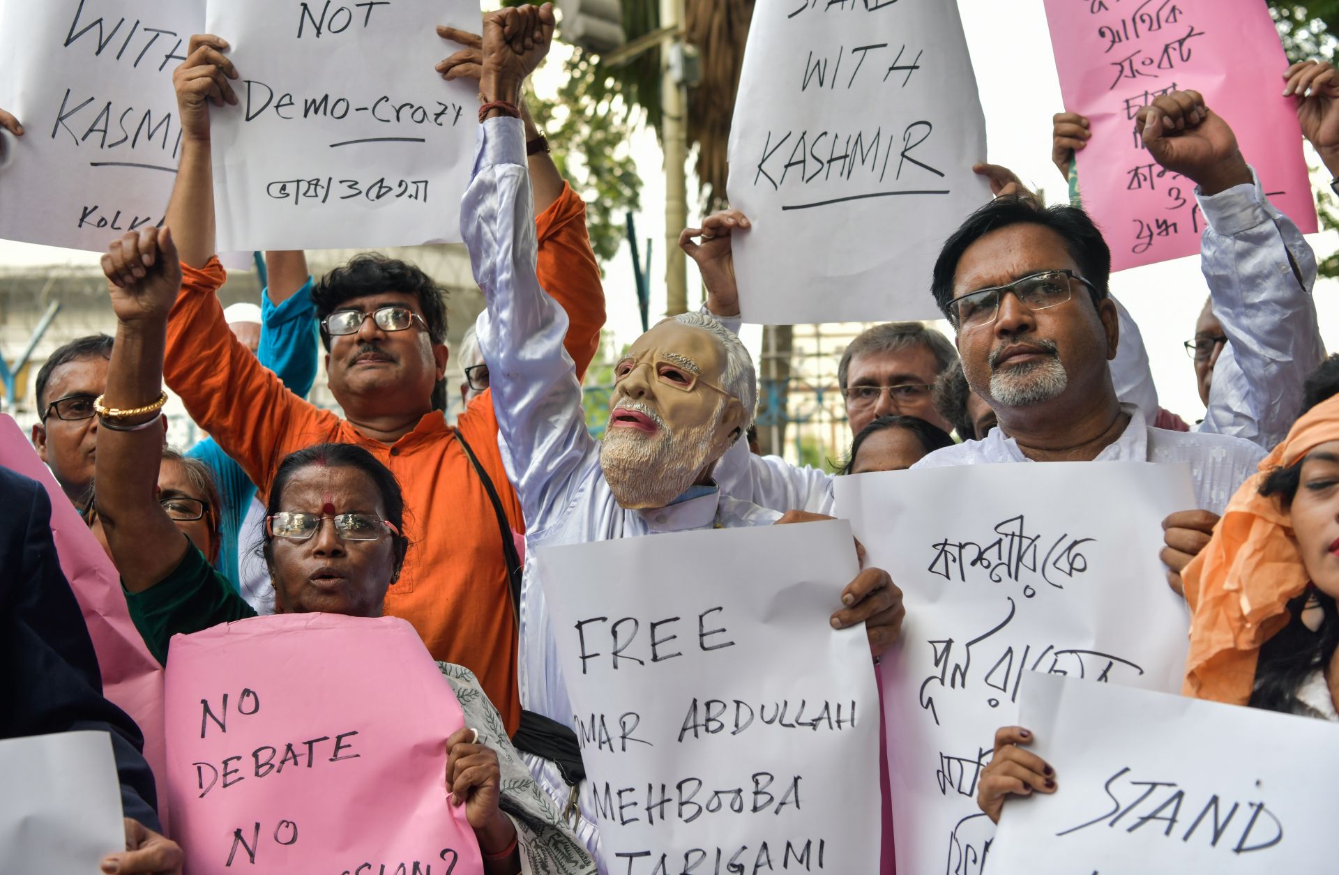 Demonstrators hold placards while shouting slogans during a protest in Kolkata on Aug. 5 at New Delhi's move to revoke Kashmir's autonomy for Jammu and Kashmir.