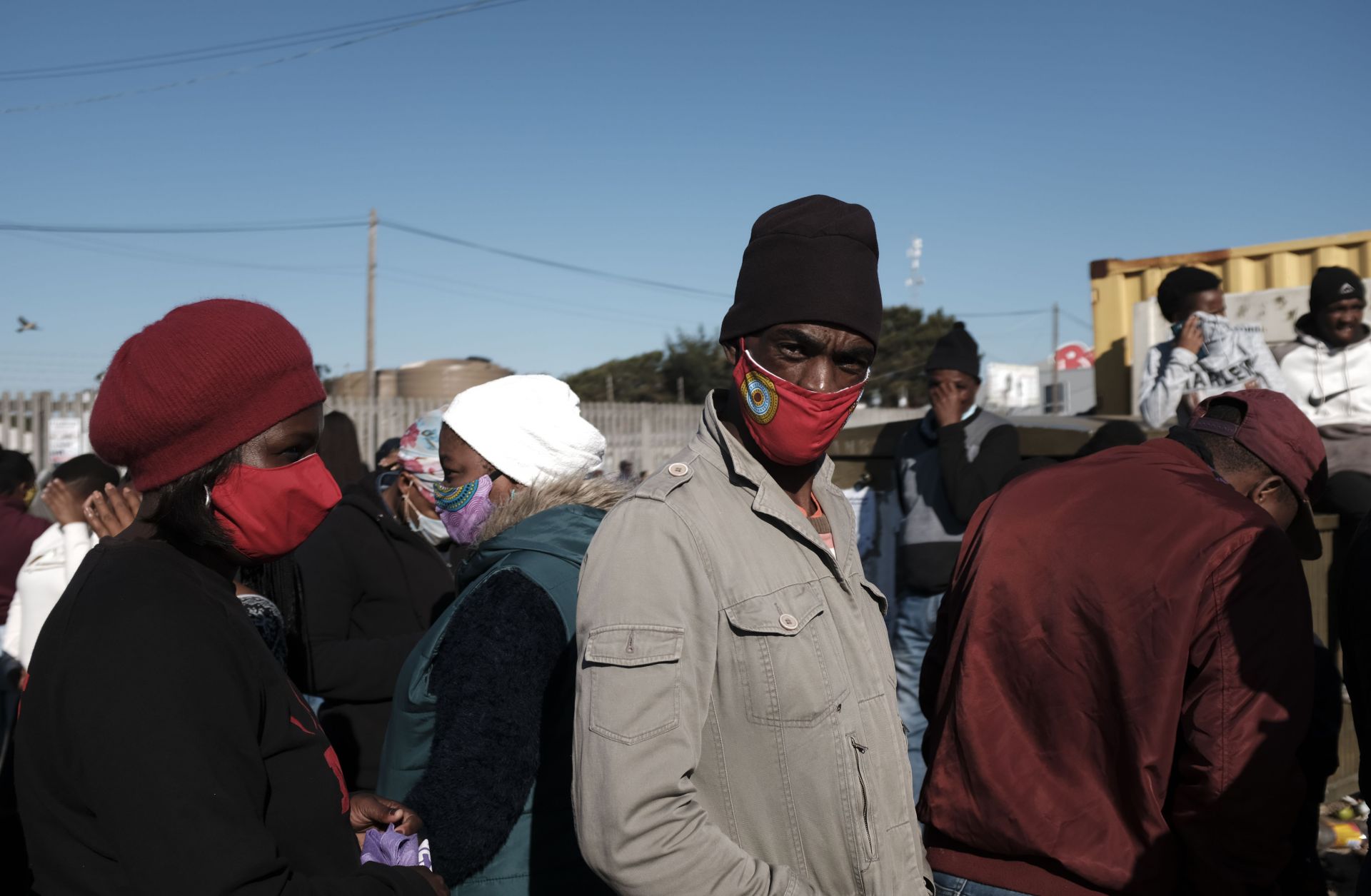 People stand in line to receive grant payments from the South African Social Security Agency (SASSA) in Khayelitsha, a township located near Cape Town, on May 4, 2020. People stand in line to receive grant payments from the South African Social Security Agency (SASSA) in Khayelitsha, a township located near Cape Town, on May 4, 2020.
