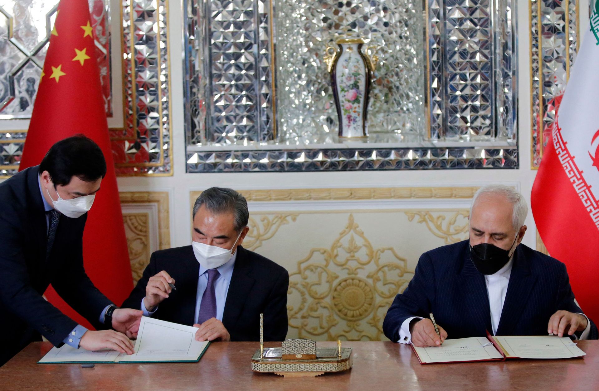 Iran and China’s foreign ministers (right to left) sign a partnership agreement in Tehran on March 27, 2021. 