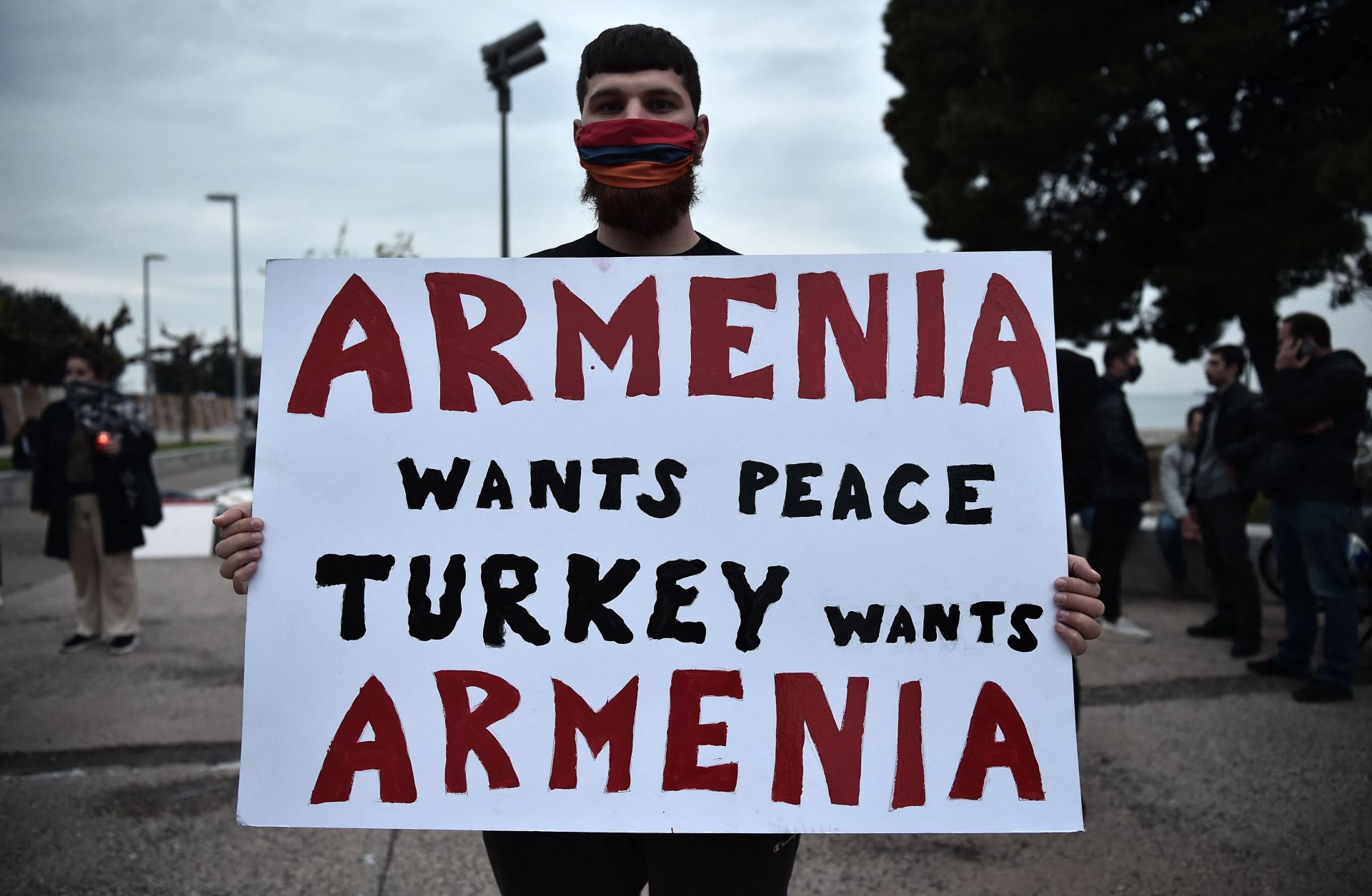 A demonstrator holds a placard during a rally in Thessaloniki, northern Greece on April 24, 2021, to commemorate the 106th anniversary of the Armenian genocide. 