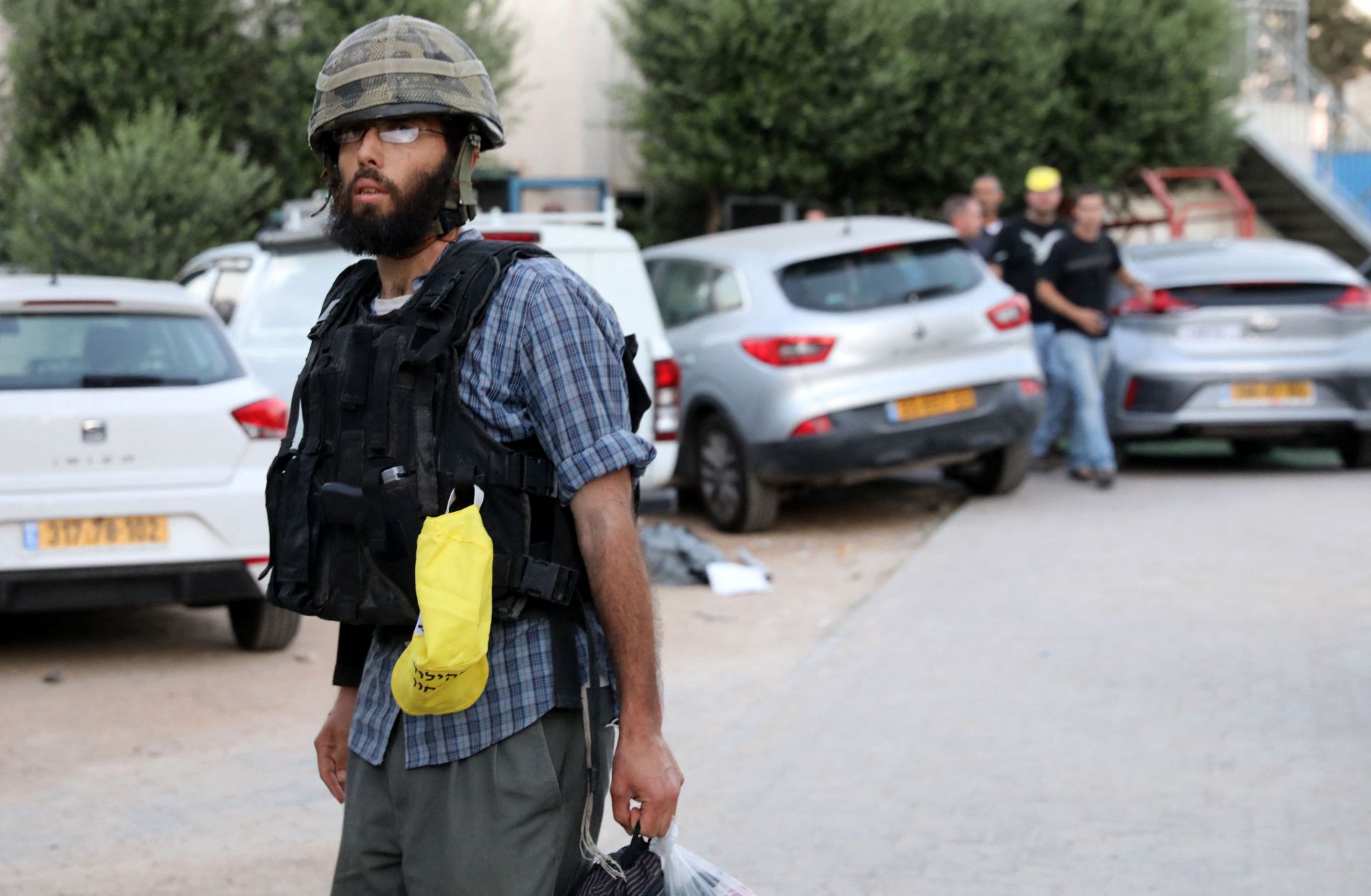 An Israeli far-right extremist walks in the street following clashes in the mixed Arab-Jewish city of Lod on May 13, 2021. An Israeli far-right extremist walks in the street following clashes in the mixed Arab-Jewish city of Lod on May 13, 2021.