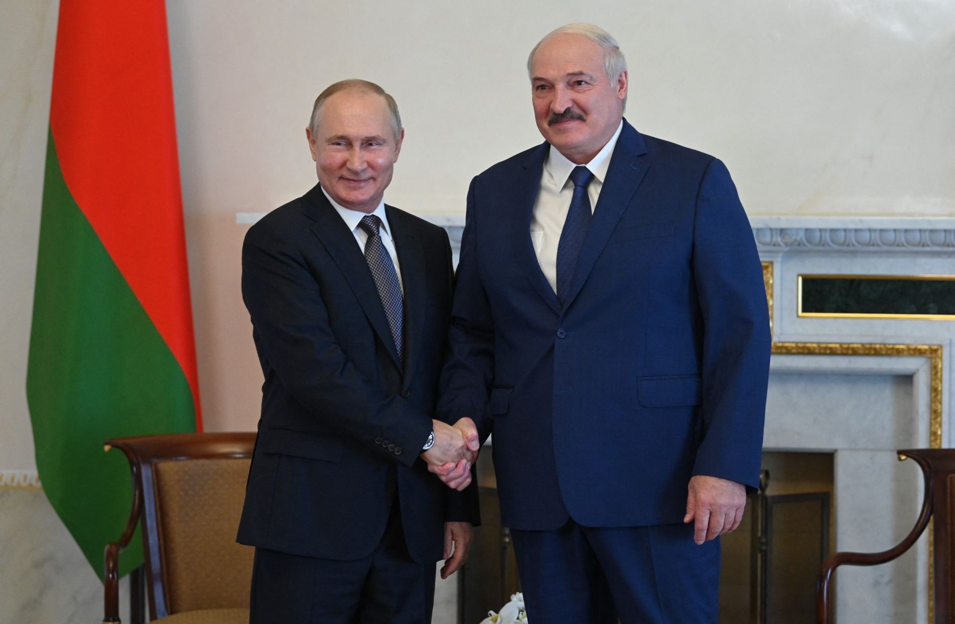 Russian President Vladimir Putin (left) shakes hands with his Belarusian counterpart Alexander Lukashenko in Saint Petersburg, Russia, on July 13, 2021. 