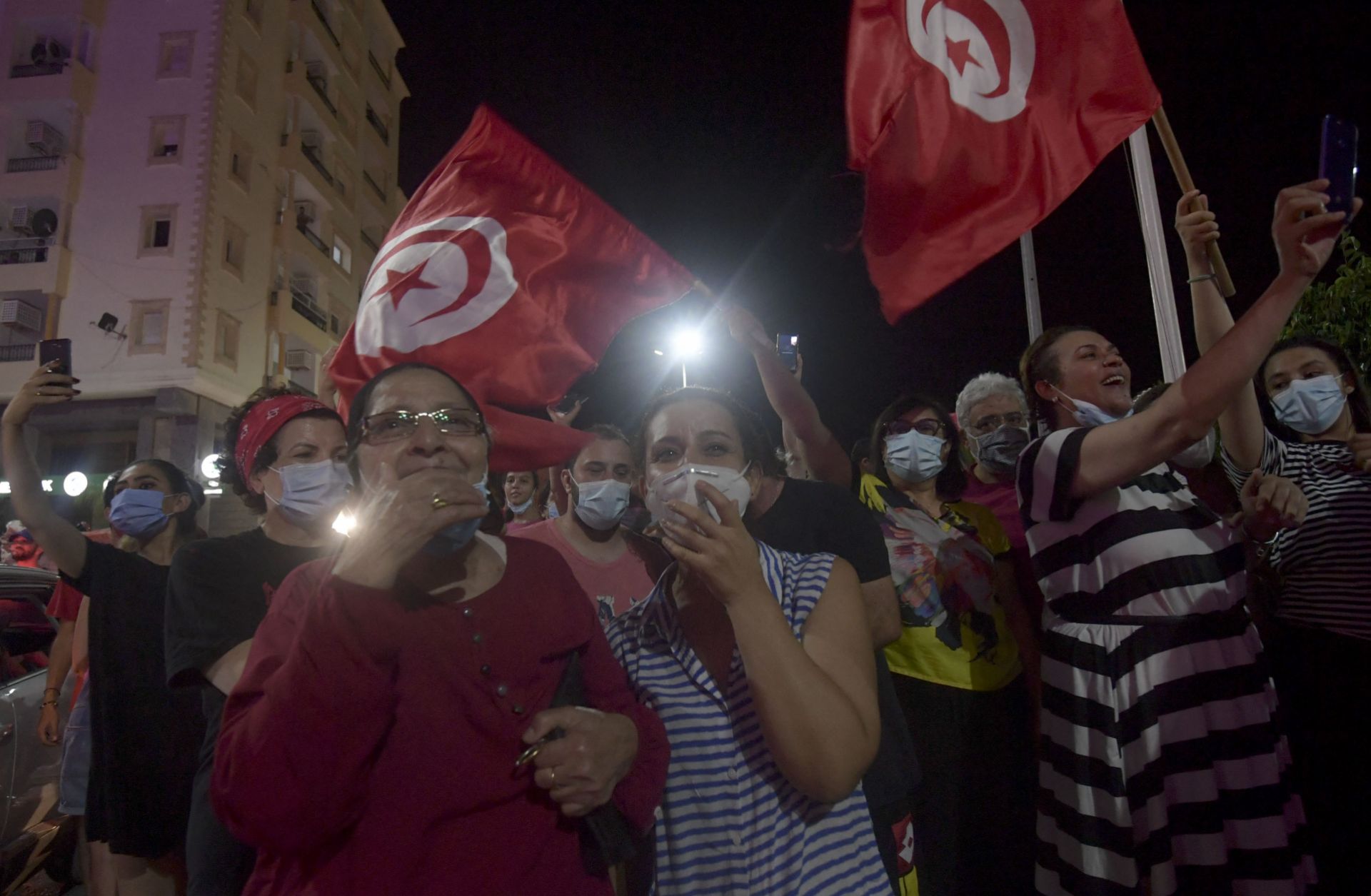 People celebrate in the streets of Tunis after Tunisian President Kais Saied announced the suspension of parliament and the dismissal of the country’s prime minister on July 25, 2021. 