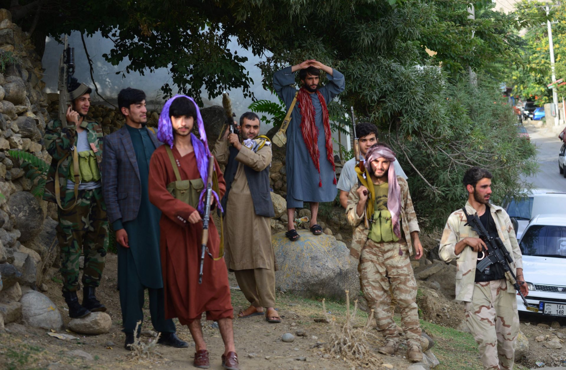 Armed men supporting Afghan security forces against the Taliban stand along a road in Panjshir on Aug. 18, 2021. 