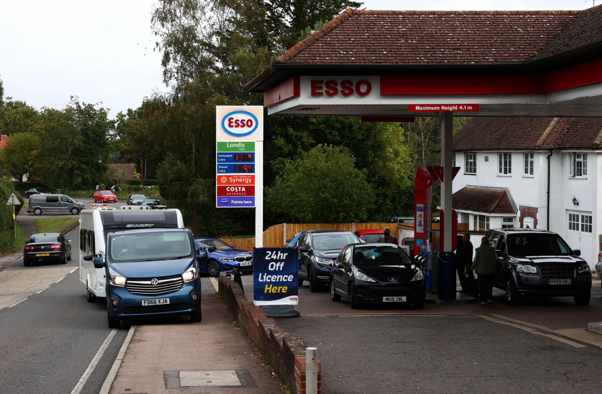 Cars line up at a gas station in the U.K. village of Odiham amid fuel shortages on Sept. 30, 2021. 
