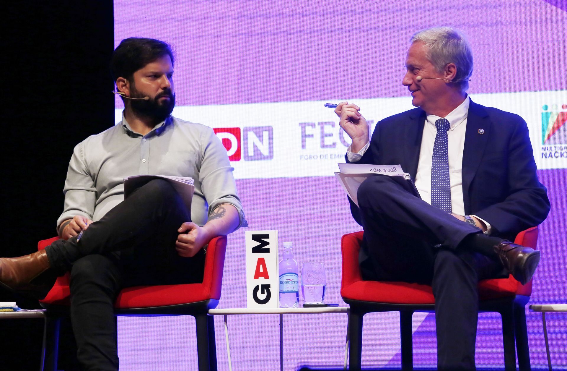 Chilean presidential candidates Gabriel Boric (left) and Jose Kast talk during a debate in Santiago, Chile, on Nov. 2, 2021. 