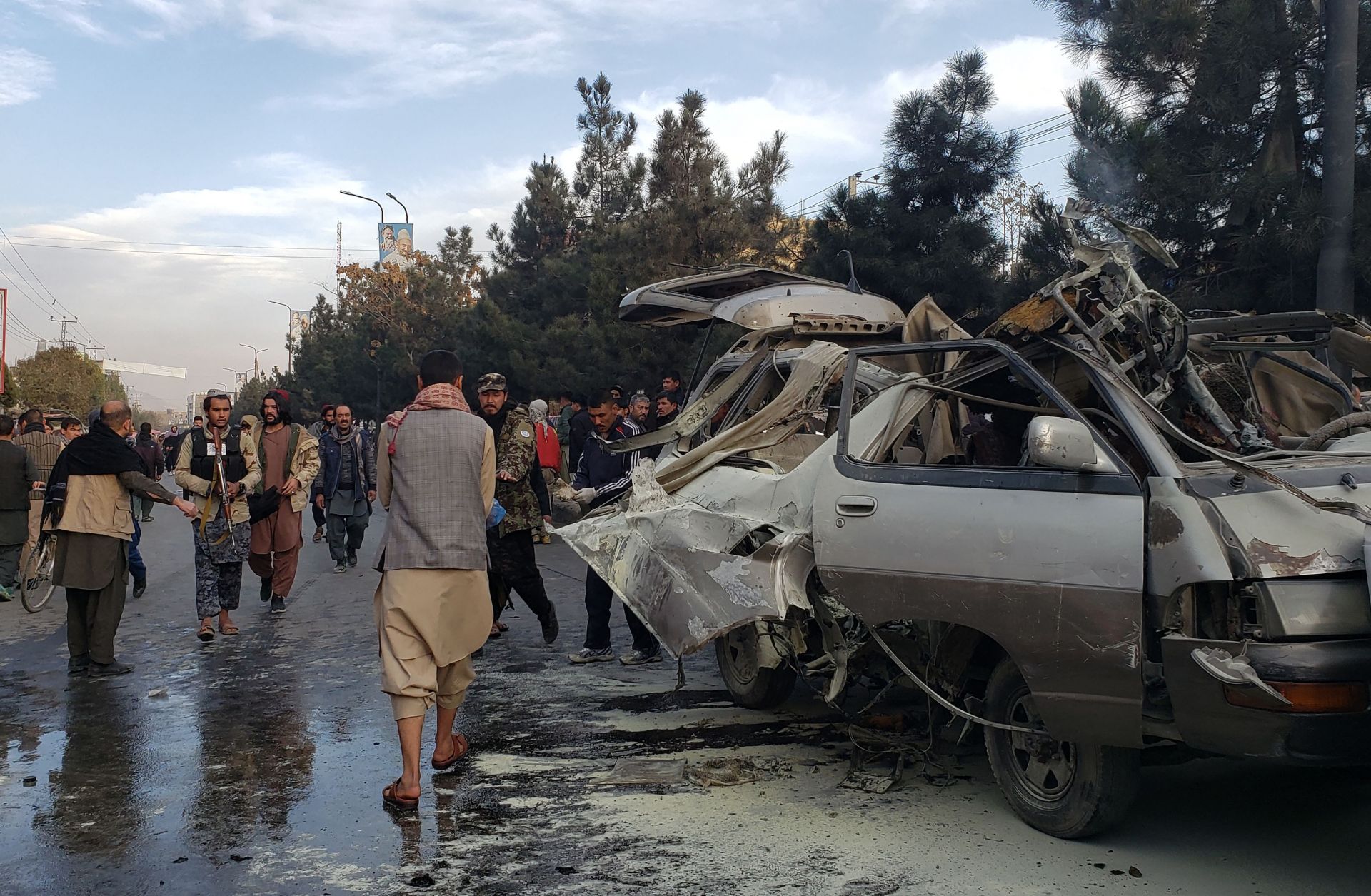 People gather next to a damaged bus damaged in a deadly bomb blast in Kabul, Afghanistan, on Nov. 17, 2021. 