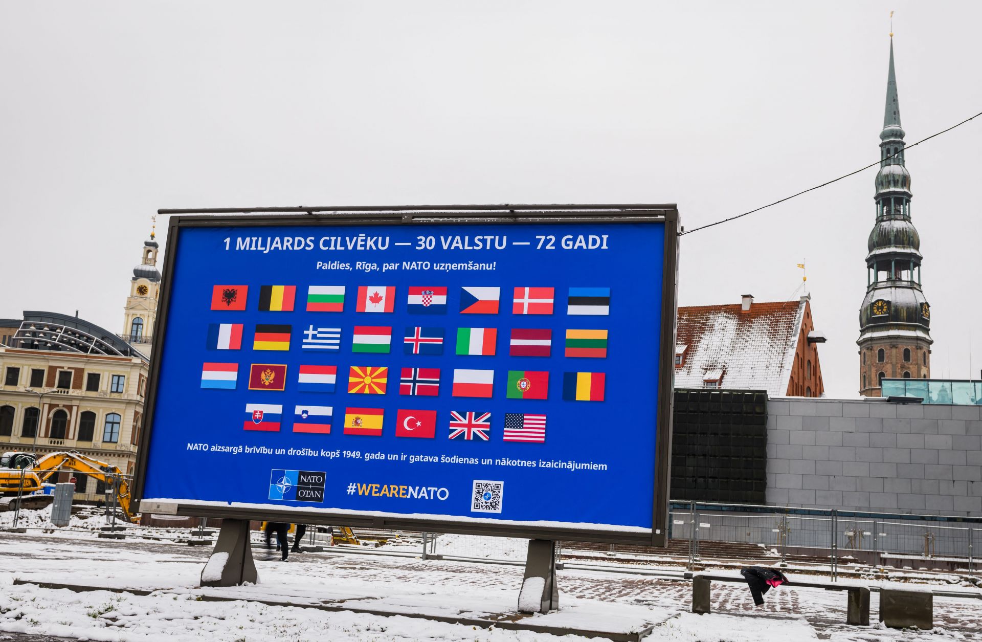 The flags of NATO member countries are seen on a billboard in Riga, Latvia, on Nov. 28, 2021, two days before the start of meetings to discuss Russia’s military buildup near Ukraine. 
