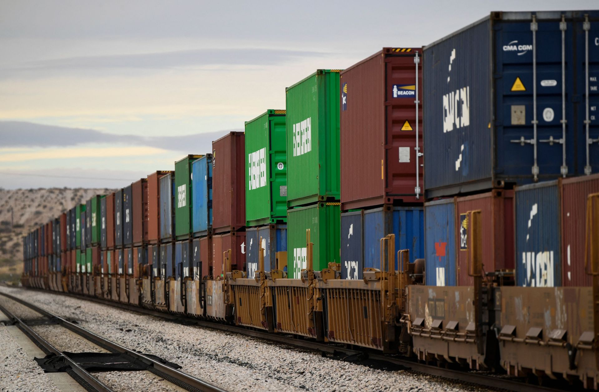 A freight train carries cargo shipping containers along the U.S.-Mexico border in Sunland Park, New Mexico, on Dec. 9, 2021 