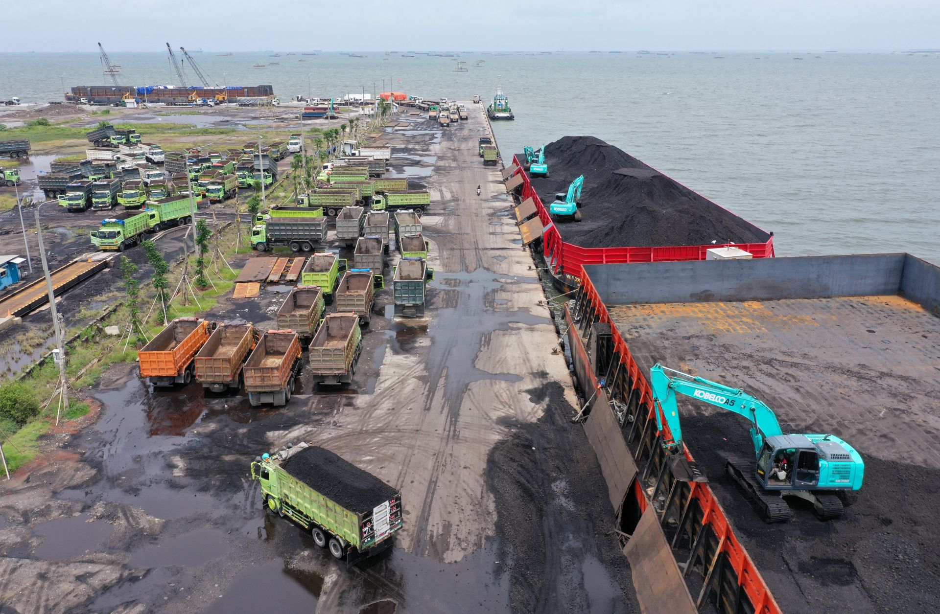 Machinery is used to load coal onto trucks at a port in Jakarta, Indonesia, on Jan. 17, 2022. 