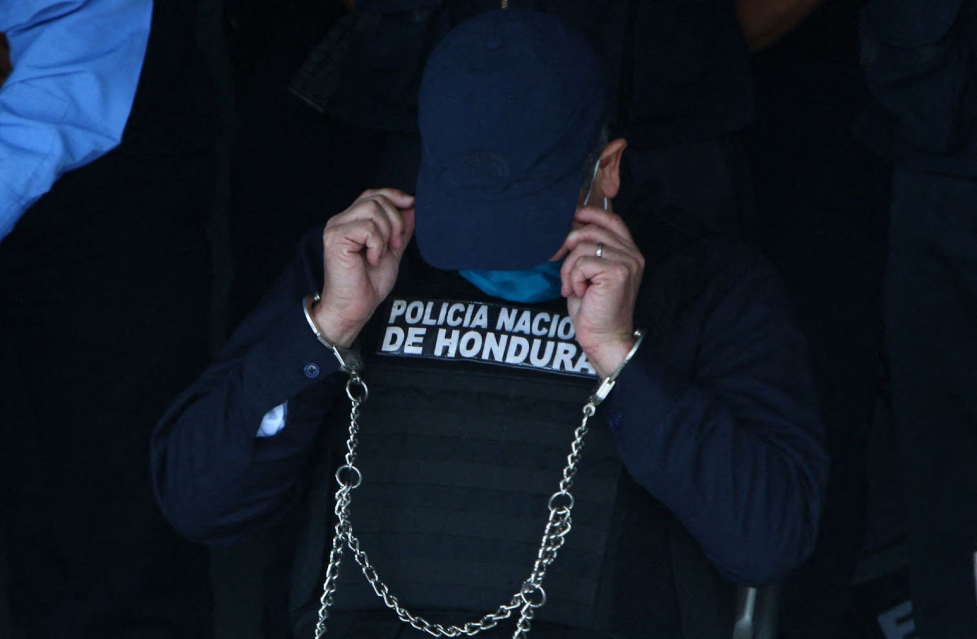 Juan Orlando Hernandez, the former president of Honduras, is seen handcuffed at the headquarters of the country’s police force in Tegucigalpa on Feb. 15, 2022. He was arrested after receiving an extradition order from the United States. 