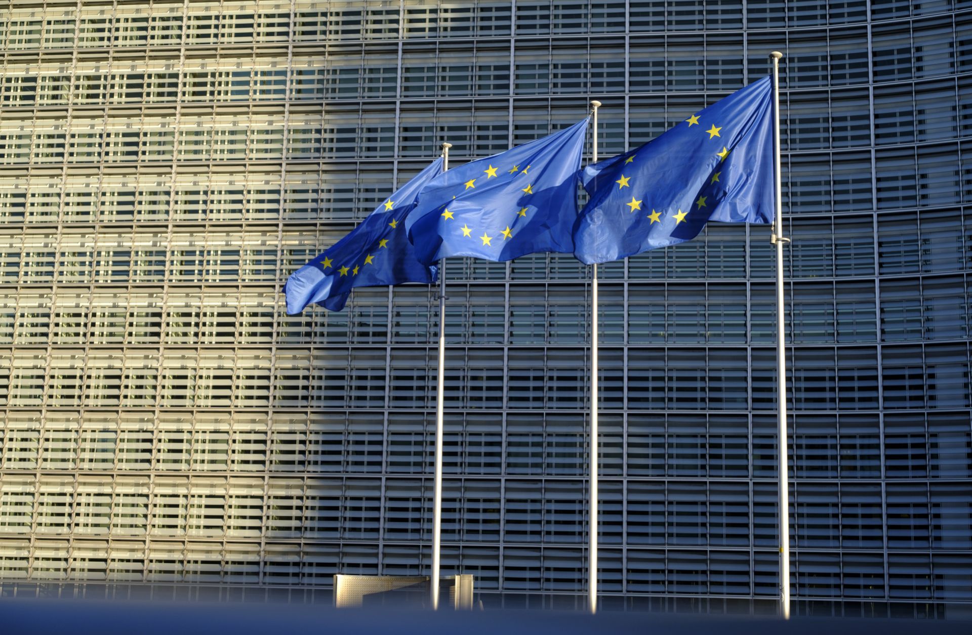 EU flags fly outside the headquarters of the European Commission on Feb. 23, 2022, in Brussels, Belgium. 
