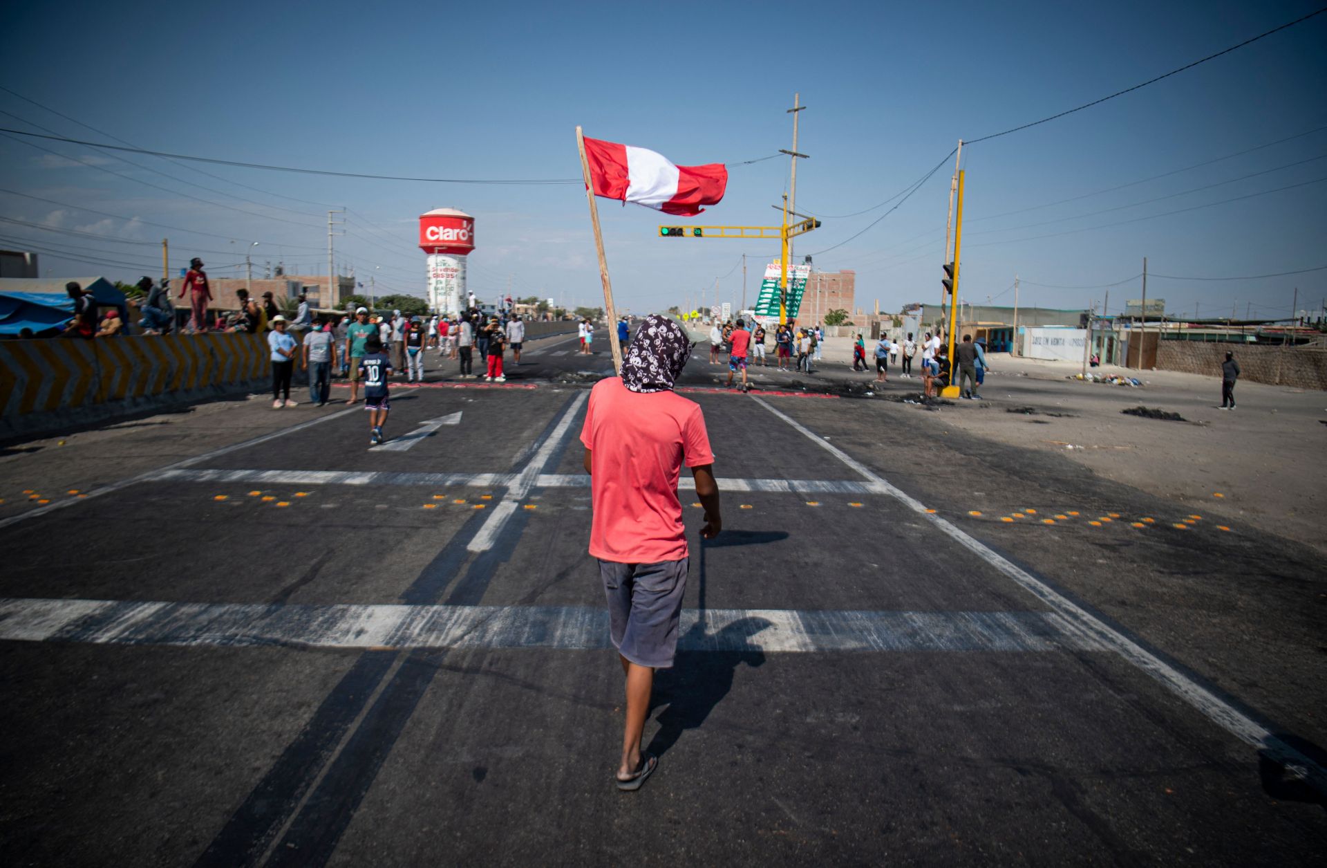 Demonstrators block a section of the Pan-American highway during a partial strike of cargo and passenger carriers in Ica, southern Peru, on April 4, 2022.
